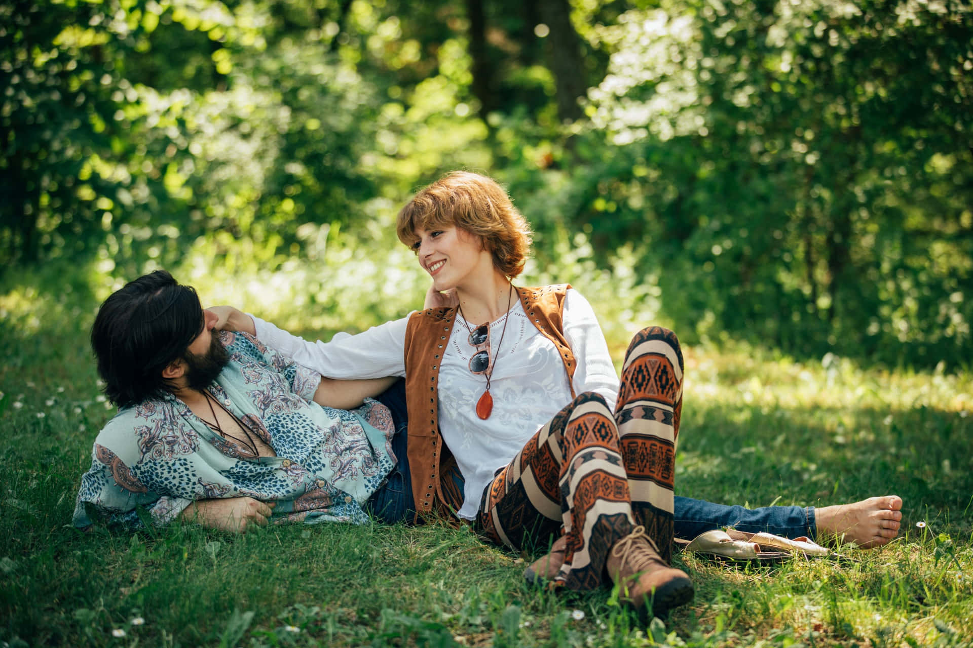 Boho Hippie Couple Relaxing Outdoors Wallpaper