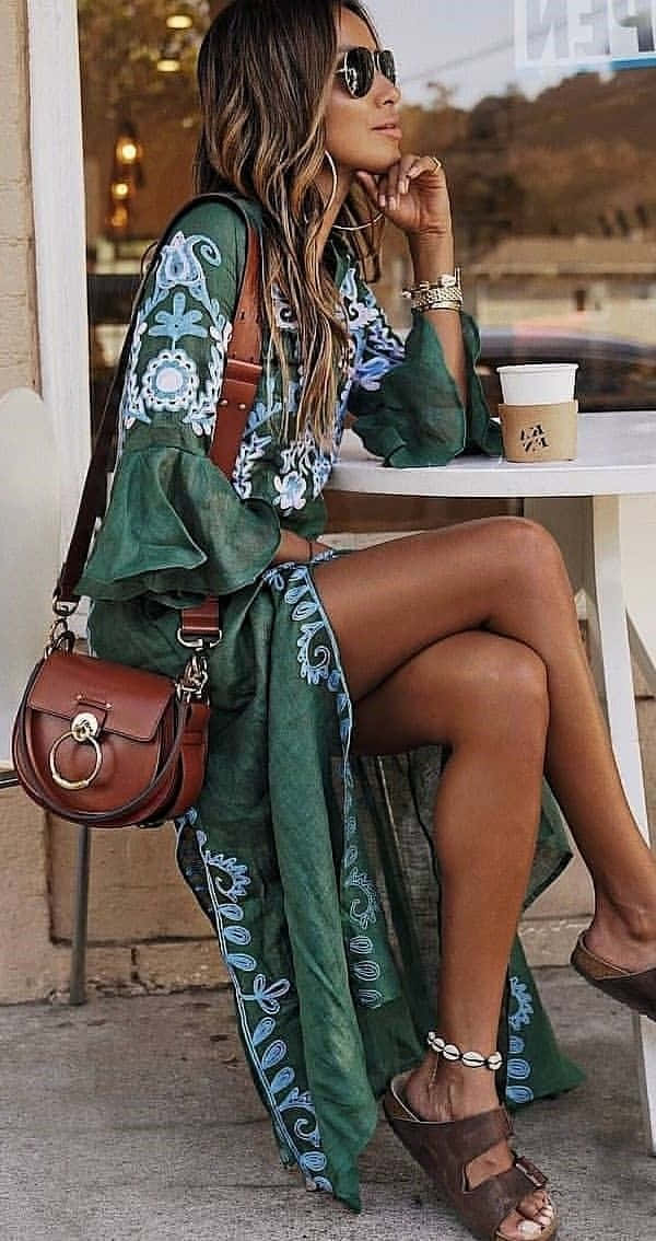 A Woman Wearing A Green Dress And Sandals