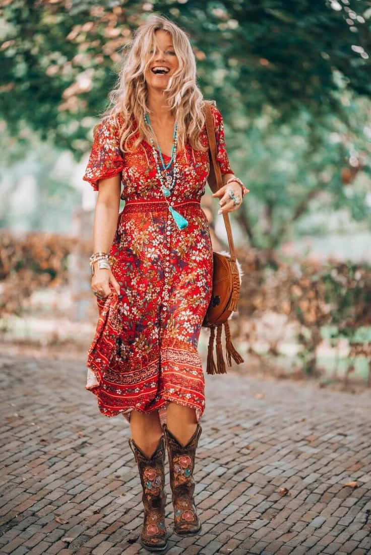 A Woman In A Red Floral Dress And Cowboy Boots