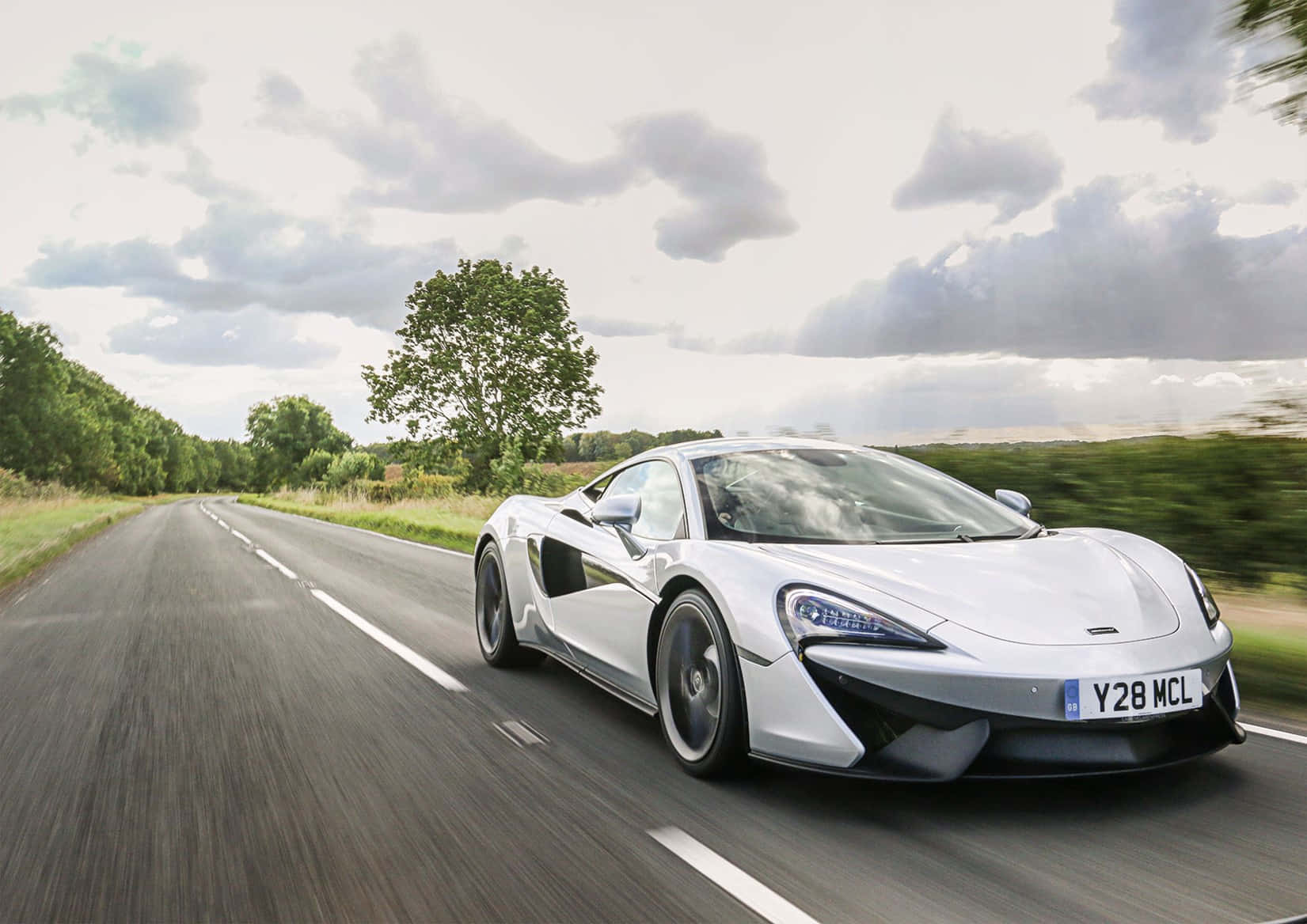 Bold Elegance: Mclaren 540c On The Road Wallpaper