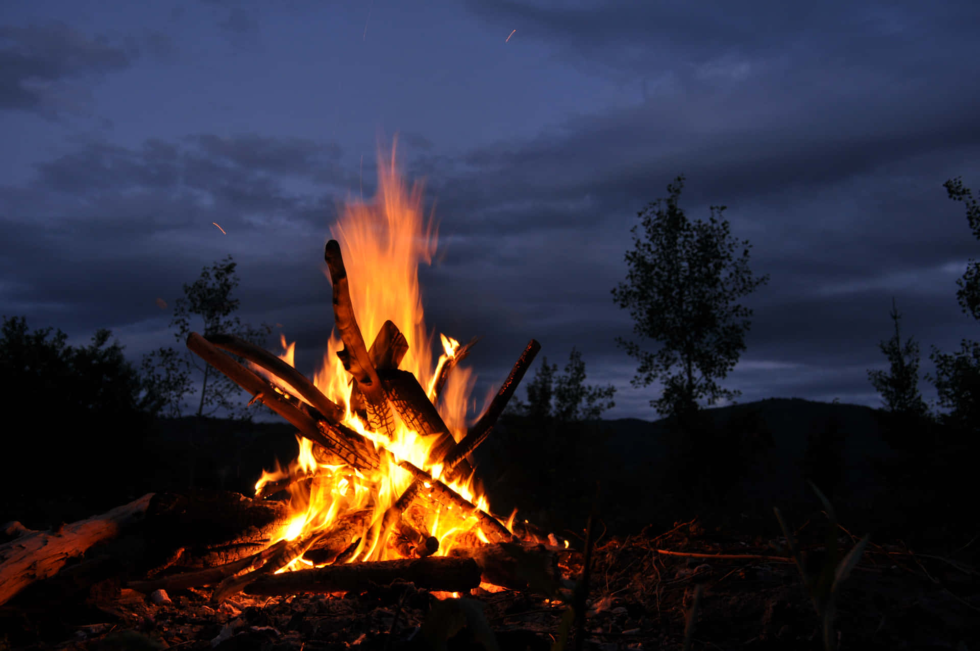 “Gathering Around a Bonfire on a Warm Night”