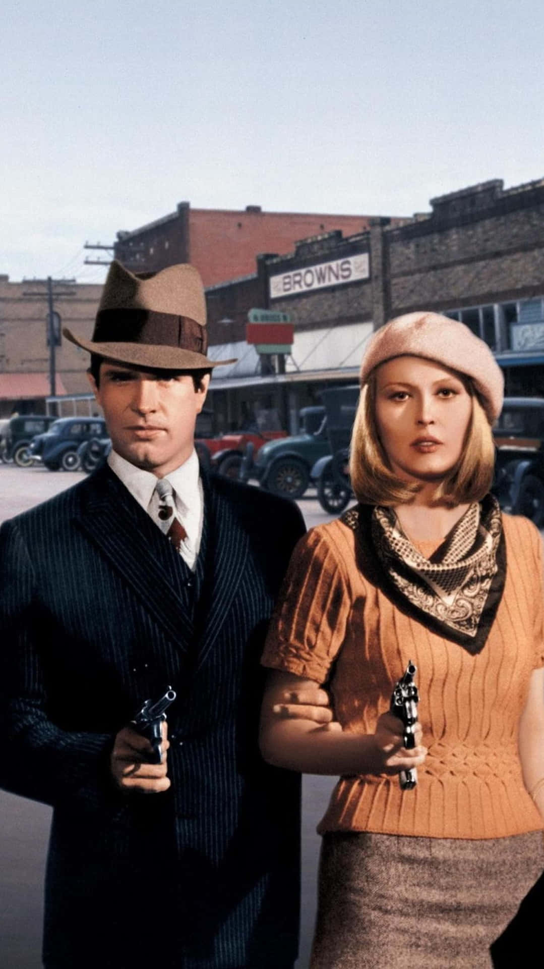A Man And Woman Holding Guns In A Street