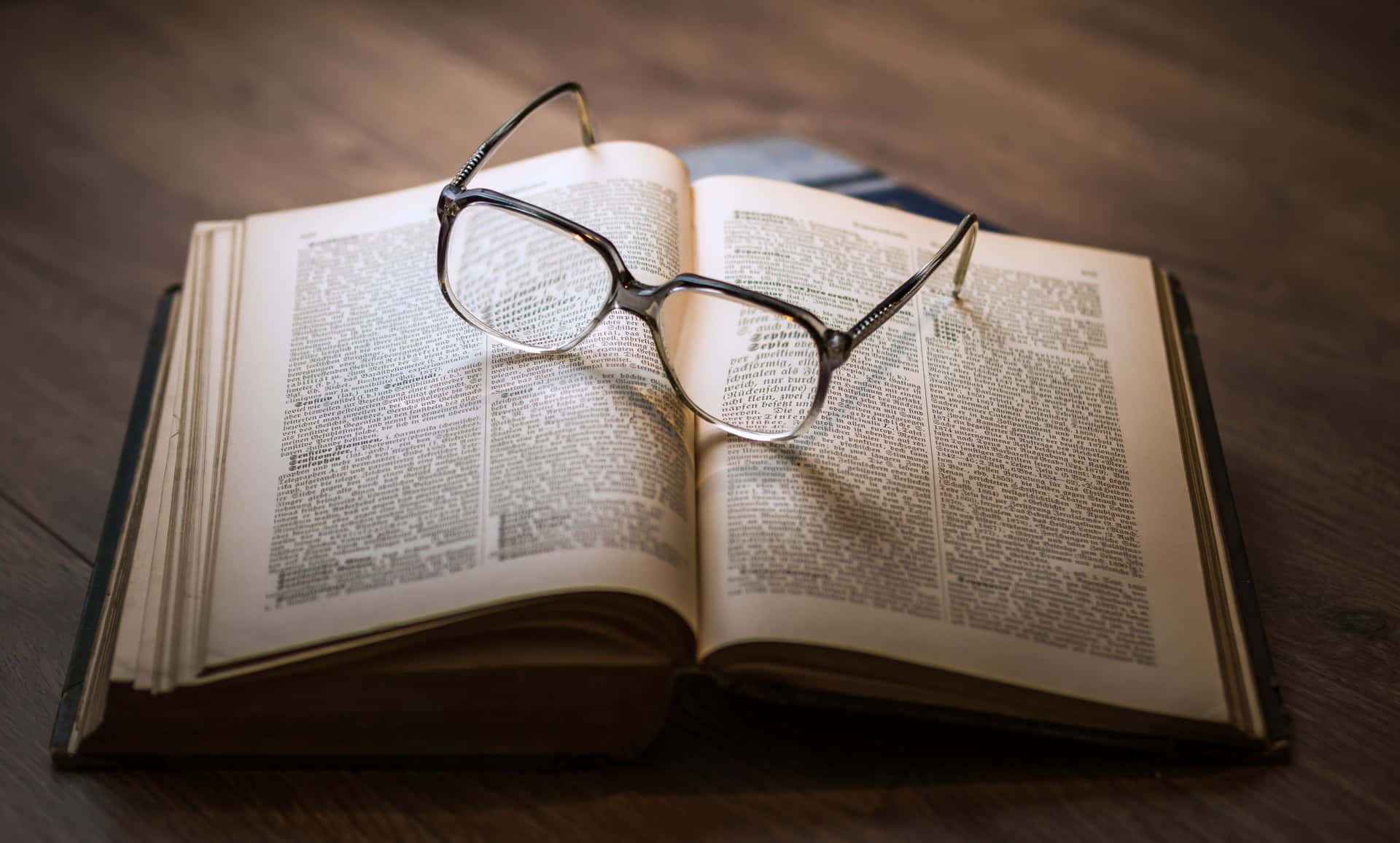 A Pair Of Glasses On An Open Book