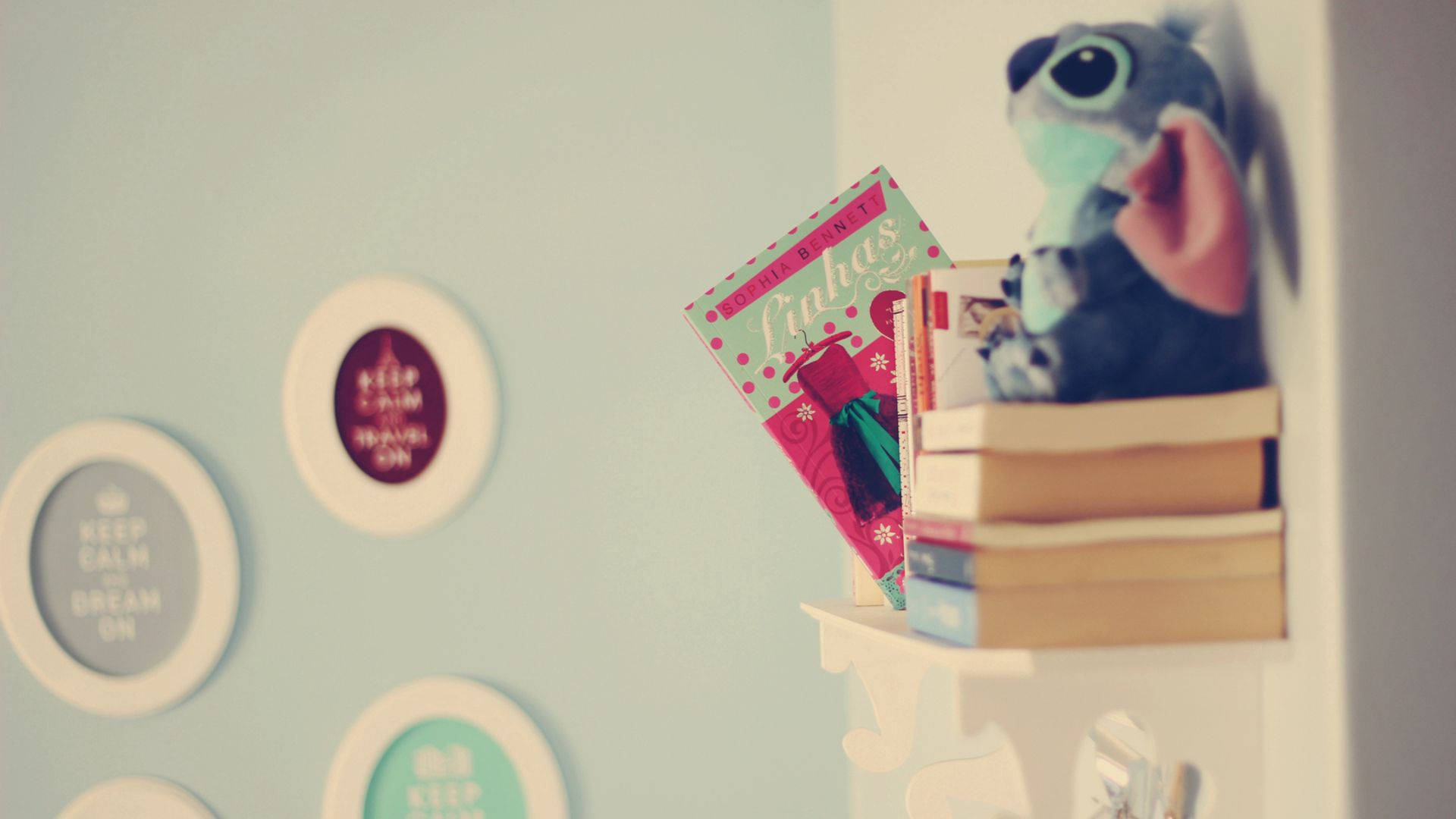 Books and Stitch stuffed toy on the shelf wallpaper