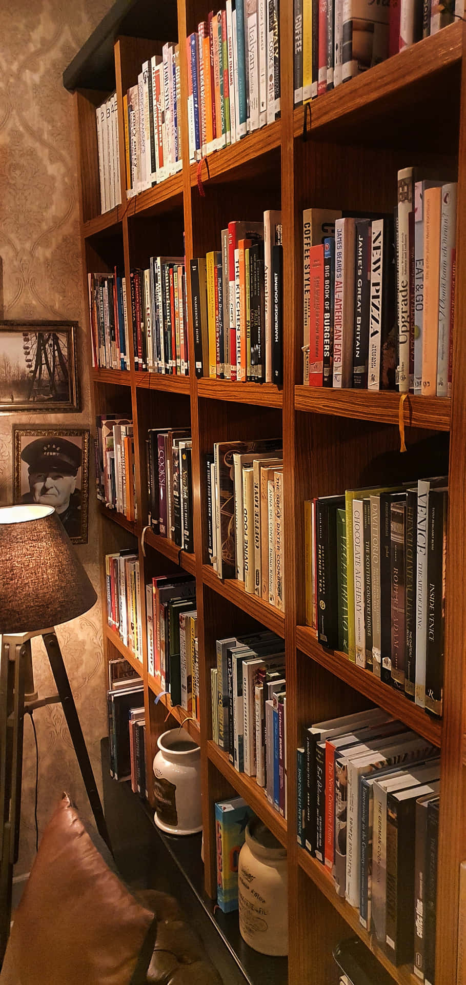 A Book Shelf With Books On It Wallpaper