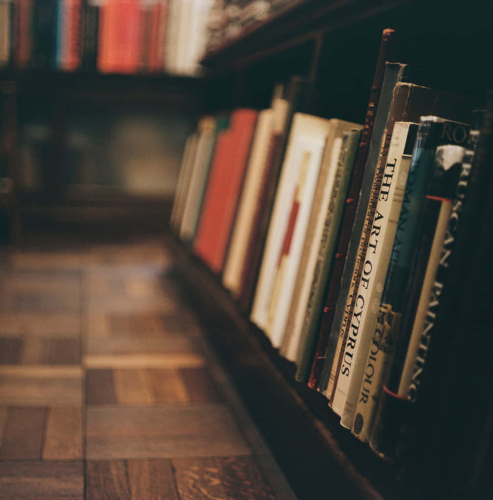 A Row Of Books On A Wooden Floor