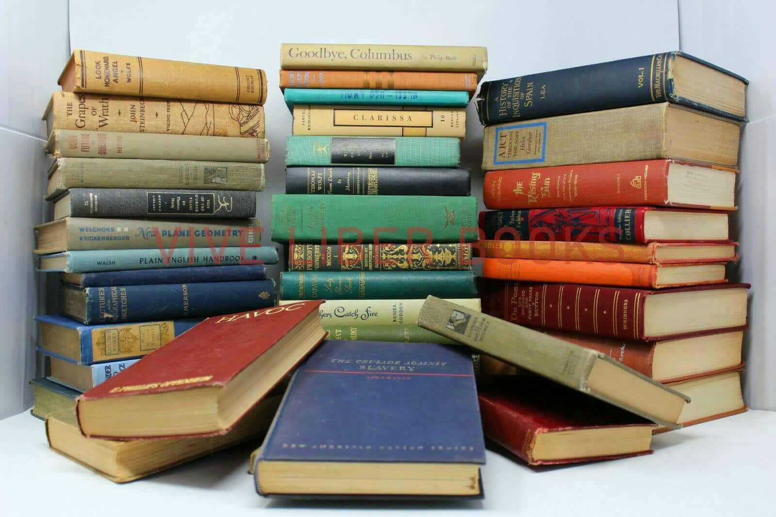 A Pile Of Old Books On A White Background