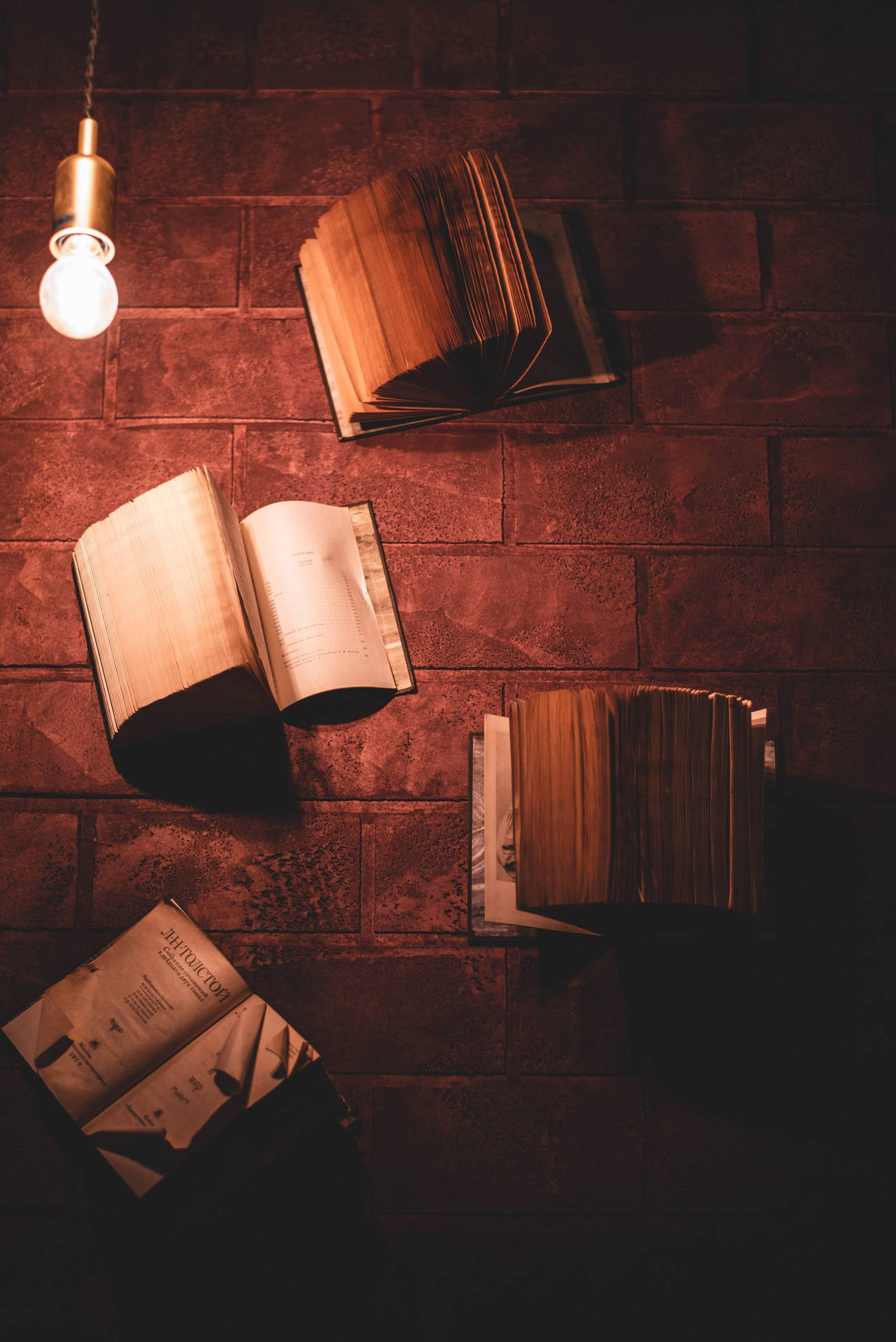 Books Placed On A Brick Surface Wallpaper
