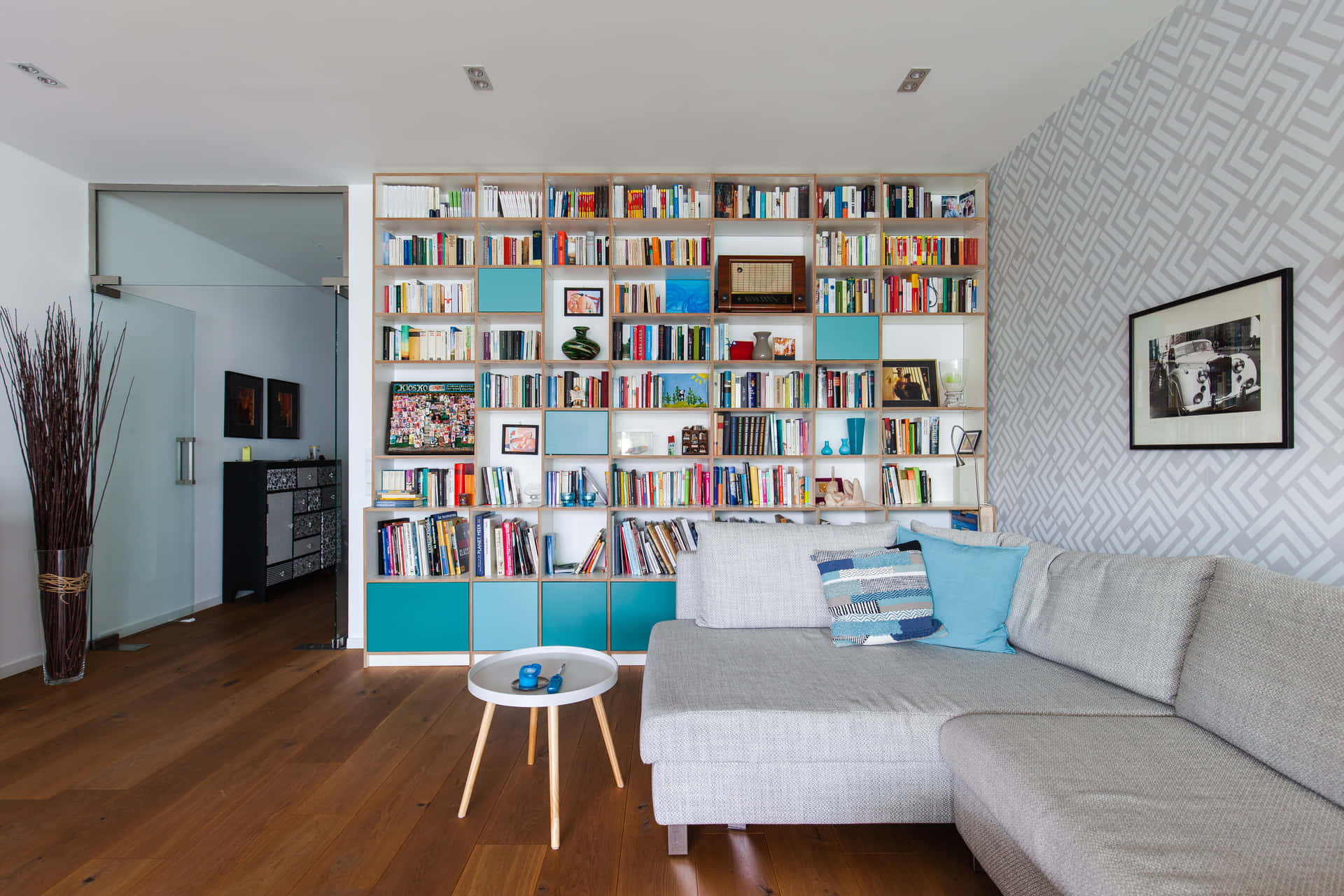 A Living Room With A Couch And A Book Shelf