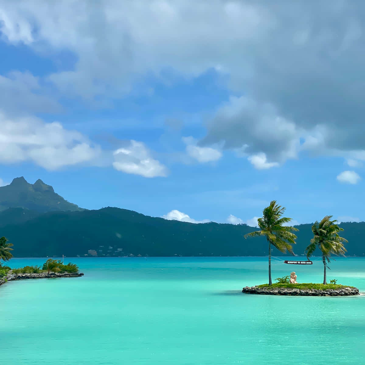 Breathtaking view of the white sands and crystal clear waters of Bora Bora Beach Wallpaper
