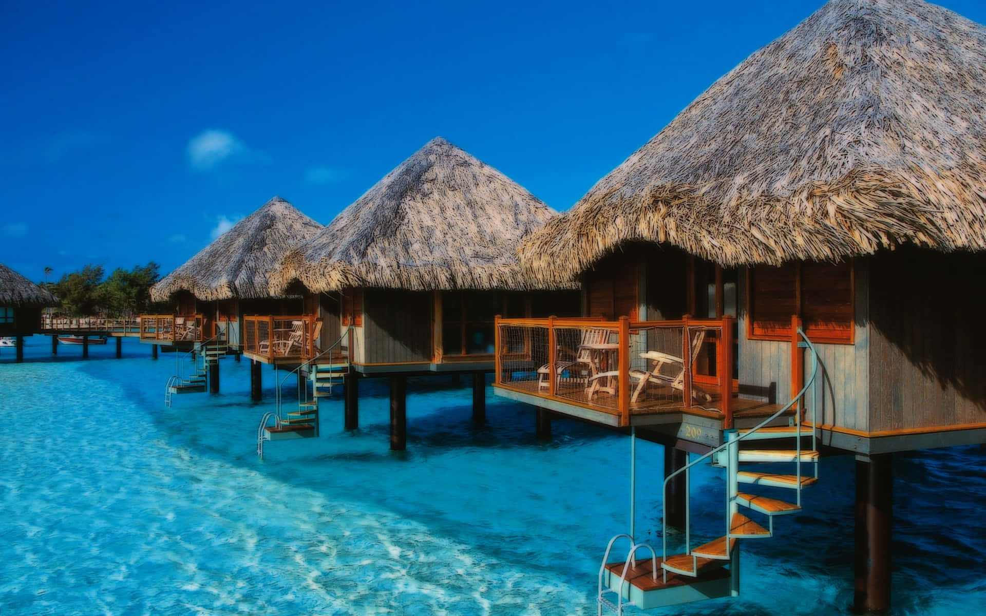 A Hut With Thatched Roofs On The Water