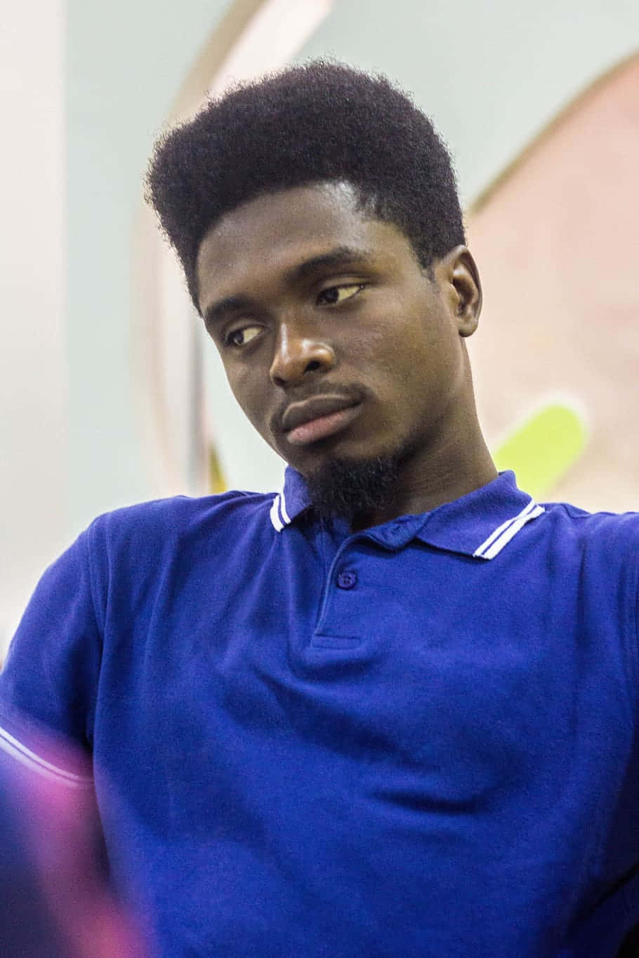 Thoughtful Nigerian Man in Blue Shirt Wallpaper