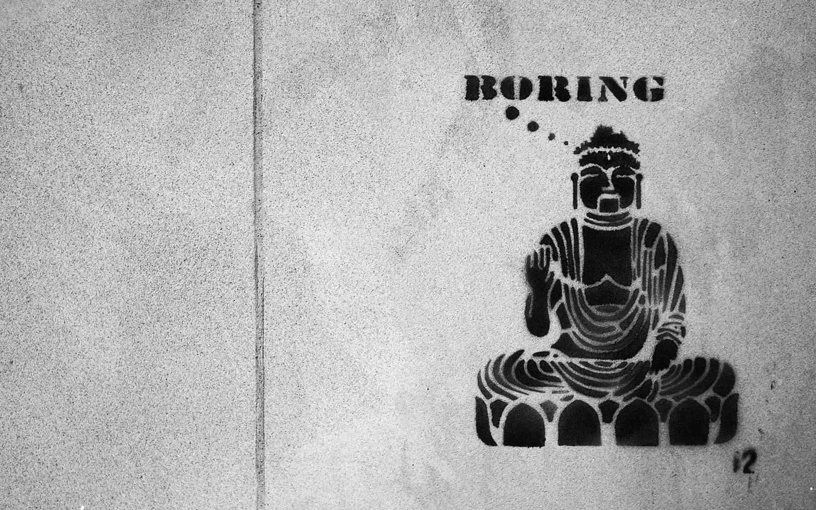 Einschwarz-weißes Foto Eines Sitzenden Buddha An Einer Wand Wallpaper