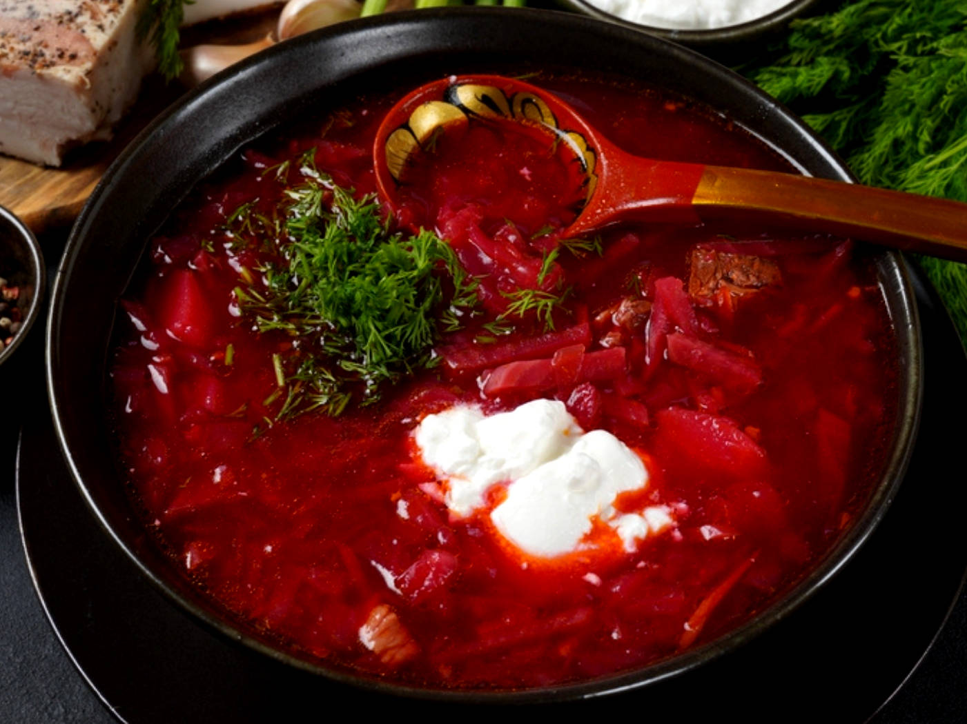 Vibrant bowl of traditional Borscht garnished with sour cream Wallpaper
