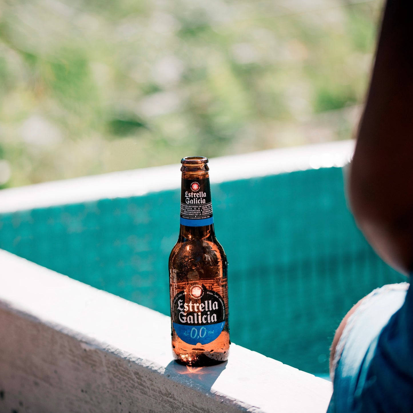 Bottle Of Estrella Galicia By The Pool Wallpaper