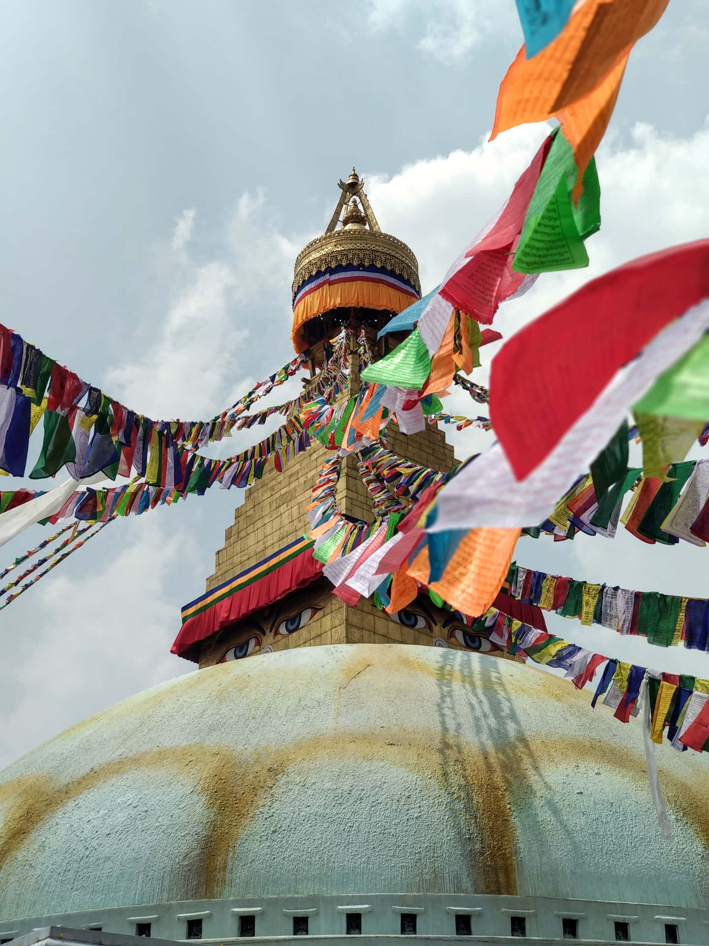 Majestic Boudhanath Stupa adorned with colorful prayer flags Wallpaper