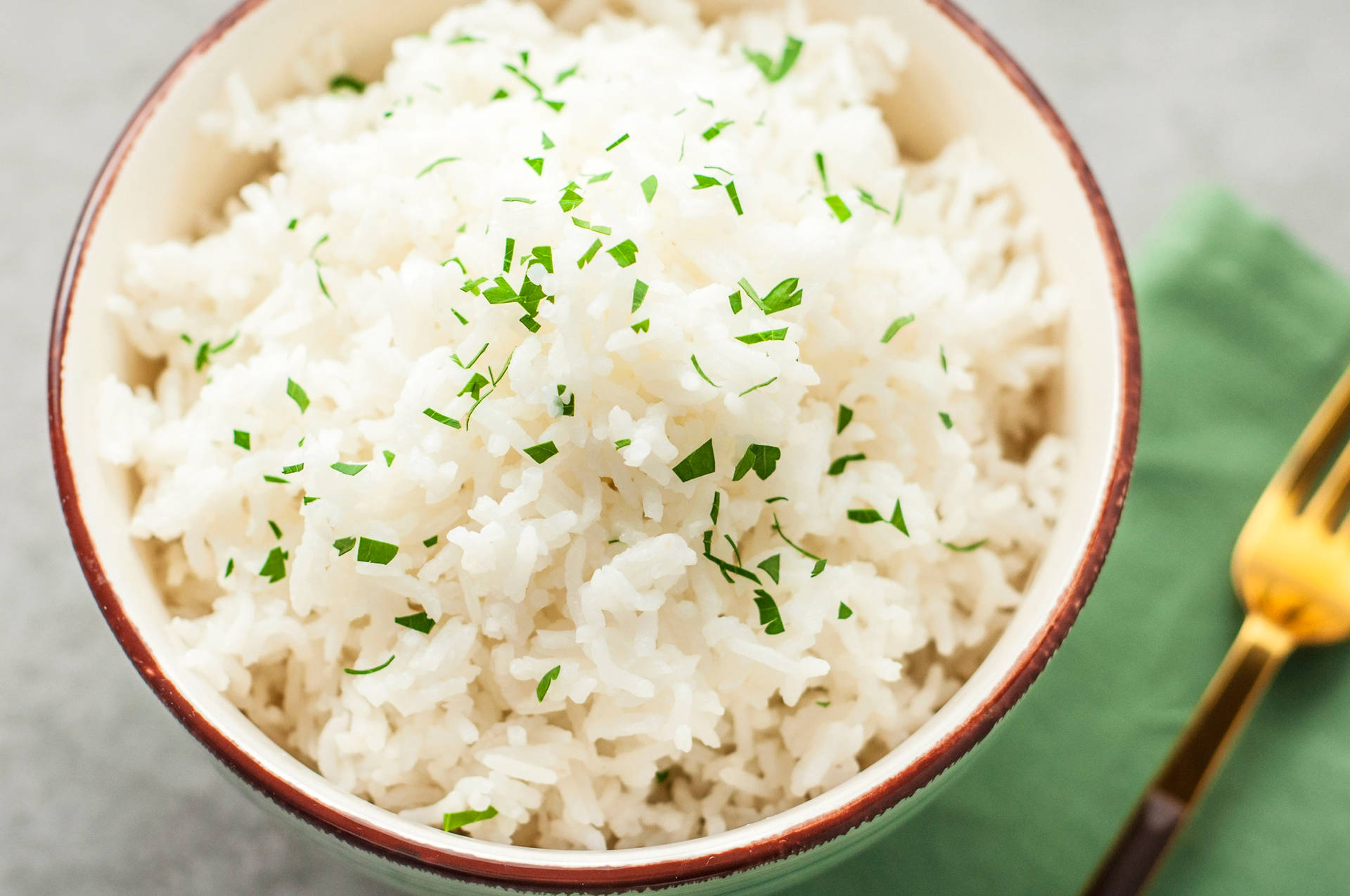 Bowl Of White Rice With An Herb Garnish Wallpaper