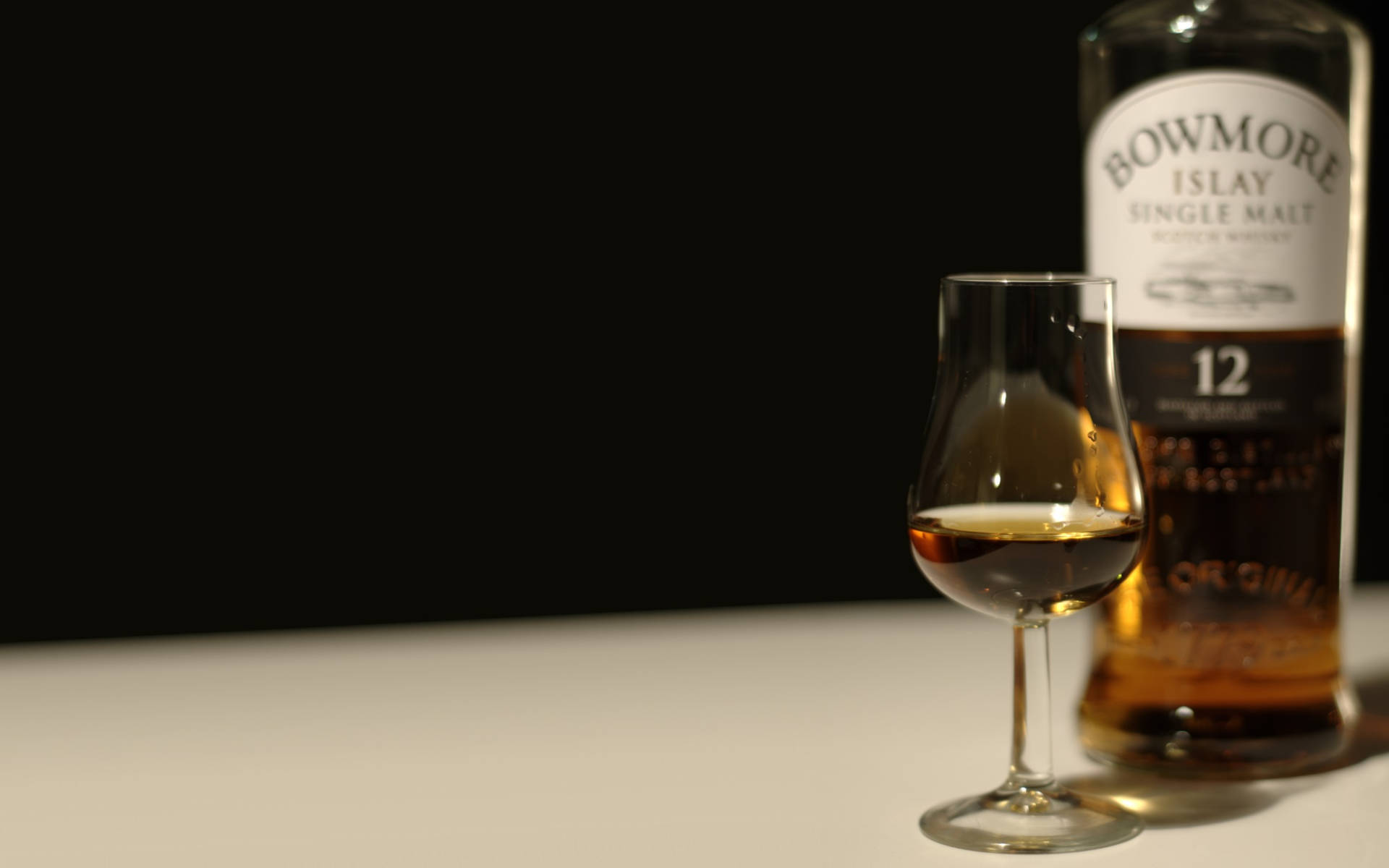 Bowmore 12 Years Old Whiskey With A Tasteful Serving Glass Wallpaper