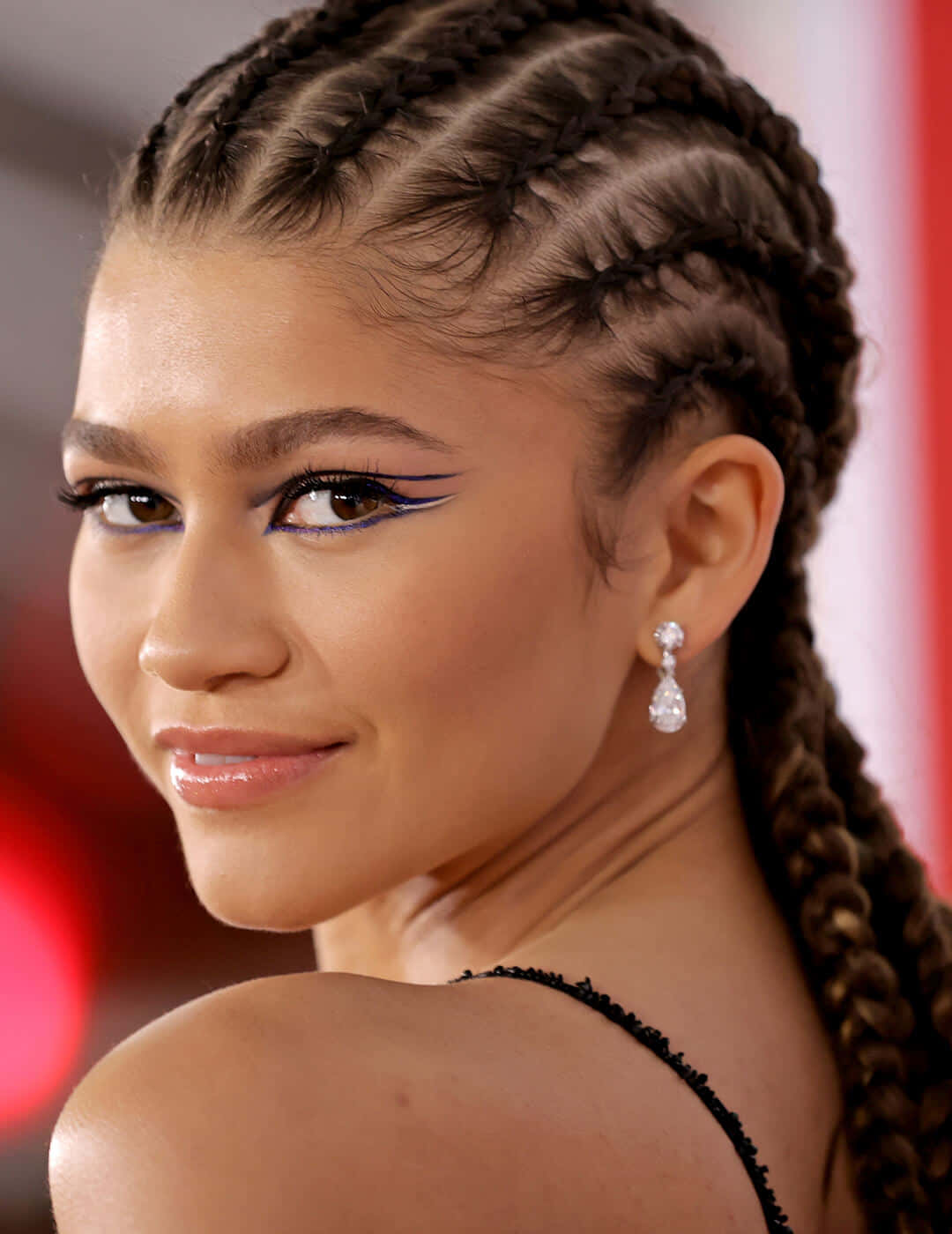A Young Woman With Braids And Earrings