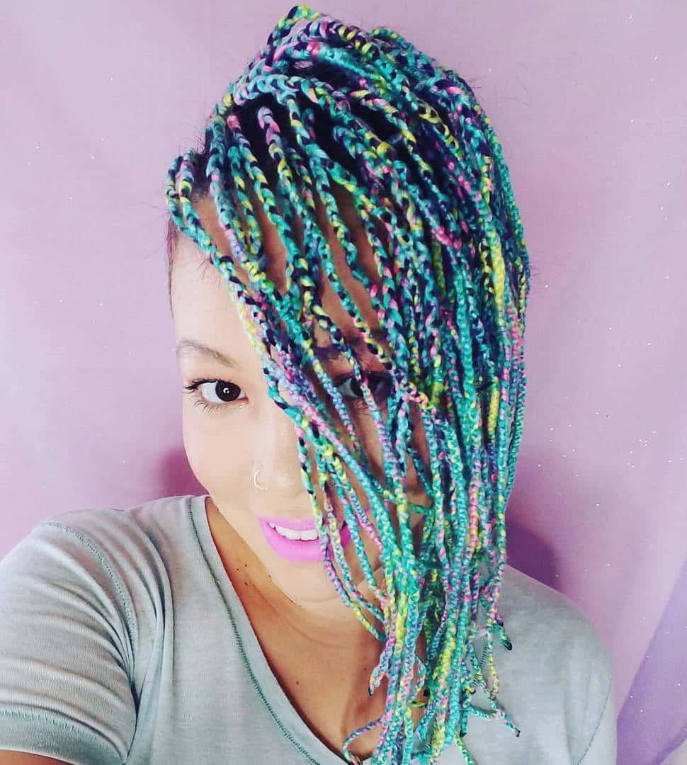 A Woman With Colorful Braids Is Posing For A Photo