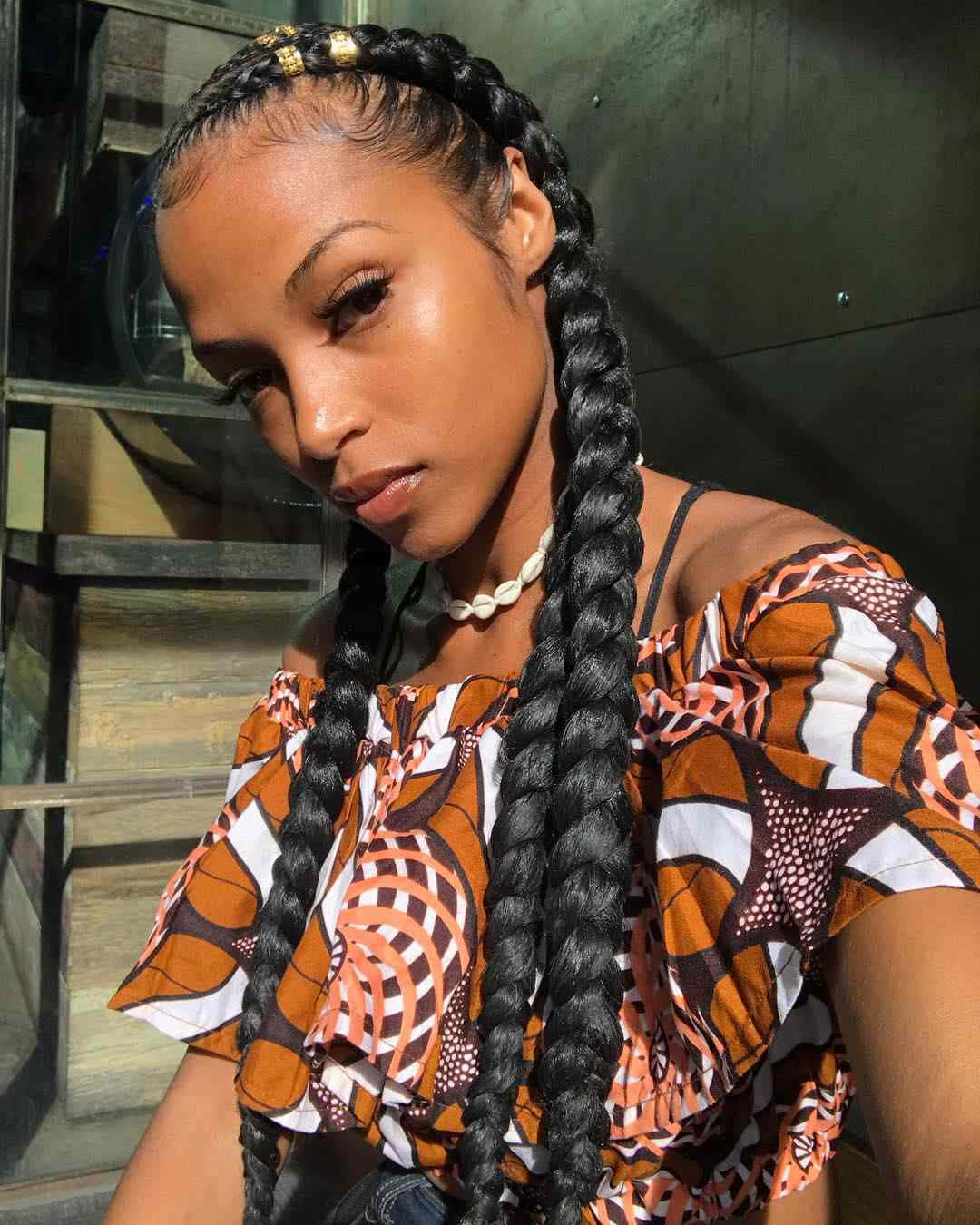 A Woman With Braids And A Top