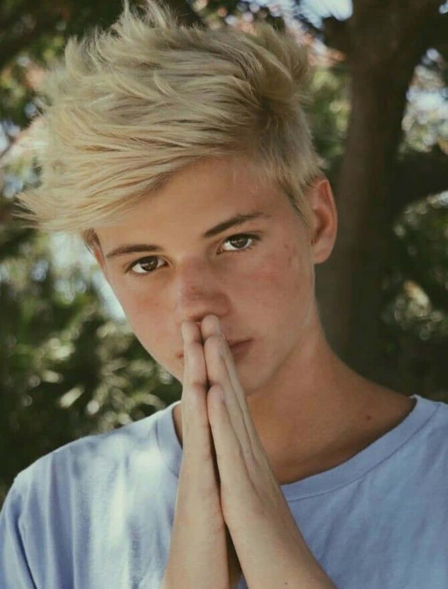 A Young Man With Blonde Hair Is Praying