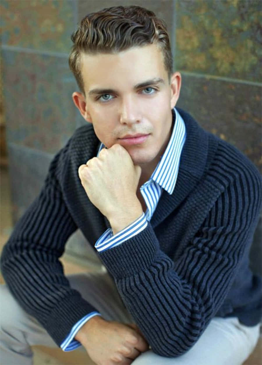 A Young Man In A Sweater And Tie