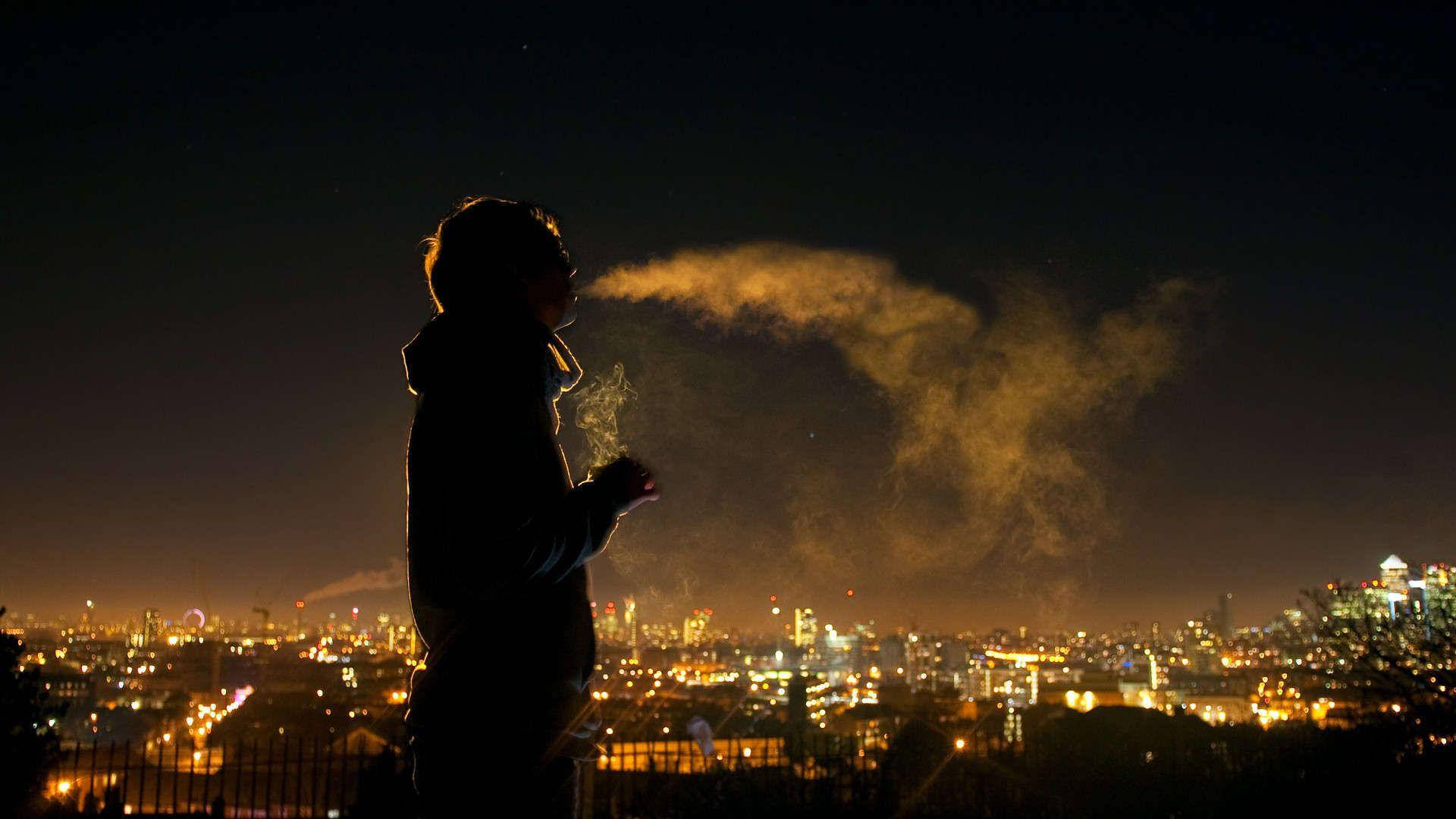 Boy Smoke Silhouette At City Backdrop Wallpaper
