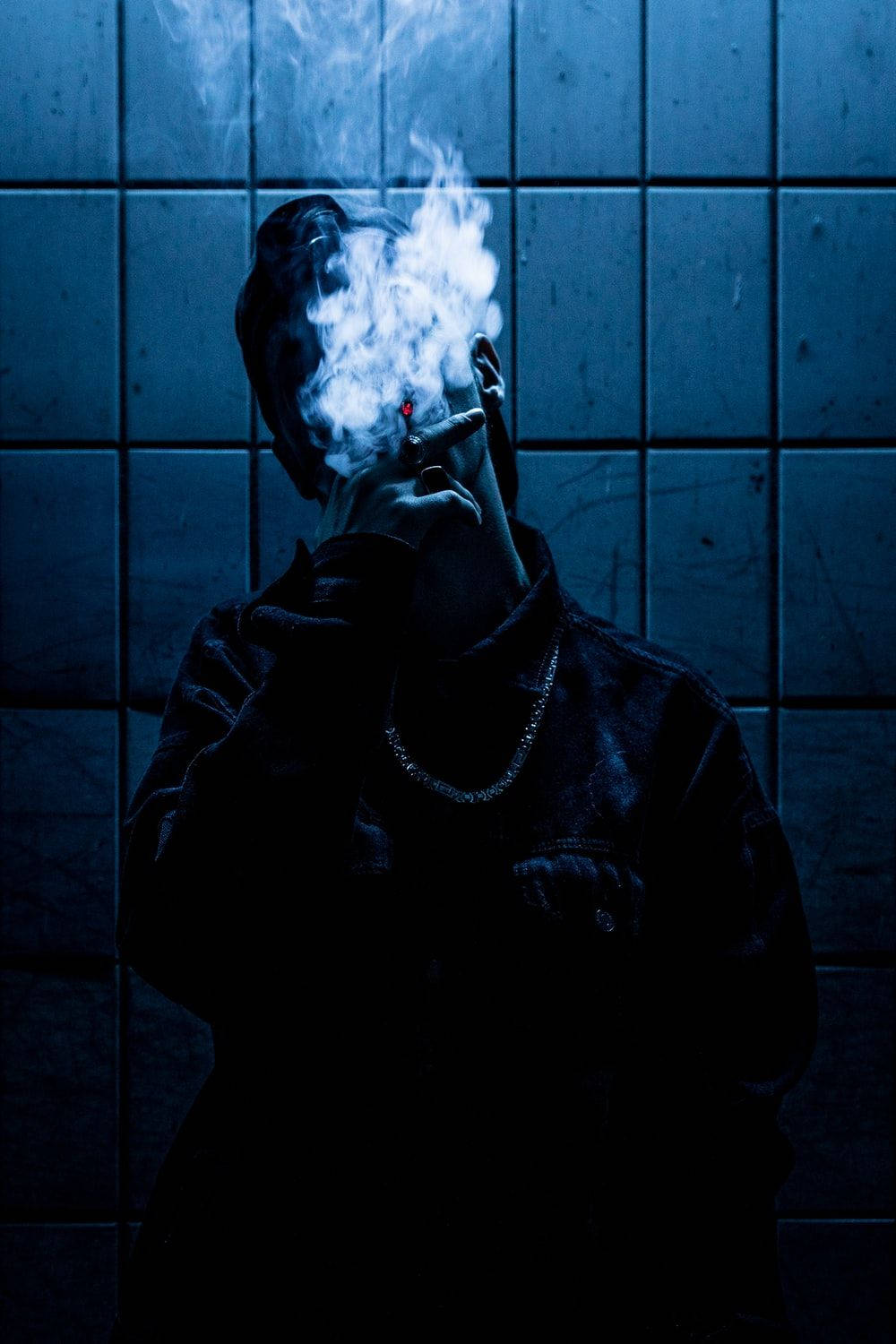 Boy Smoke With Rugged Tile Wall Wallpaper