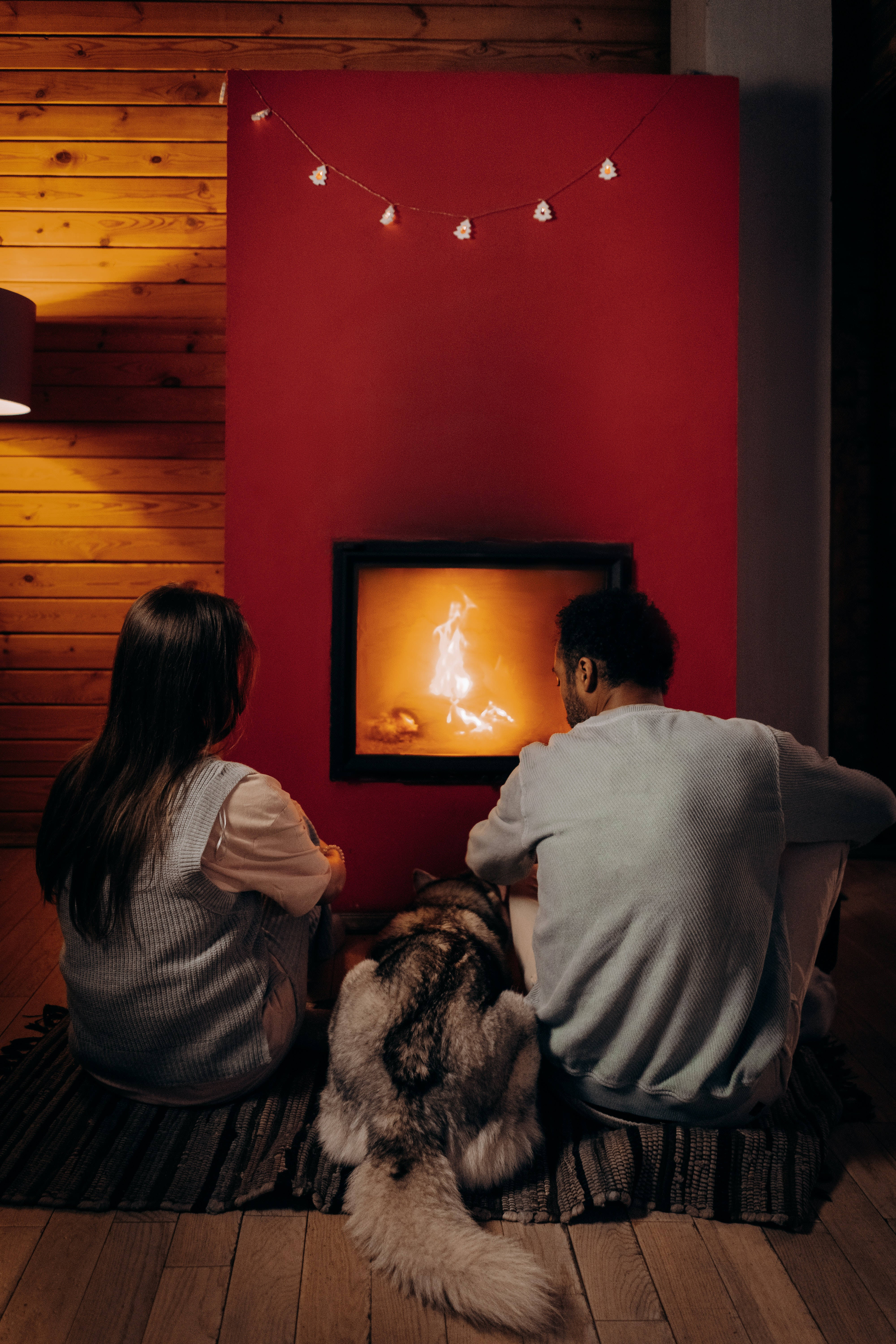 Boyfriend And Girlfriend And Dog Near Fireplace Wallpaper