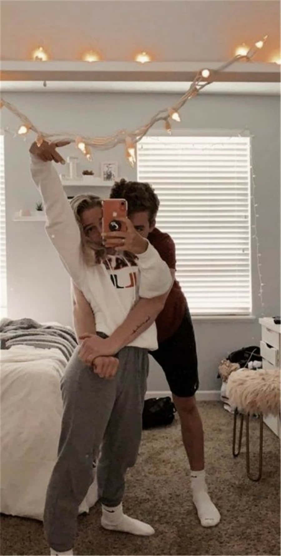 A Couple Taking A Selfie In Their Bedroom