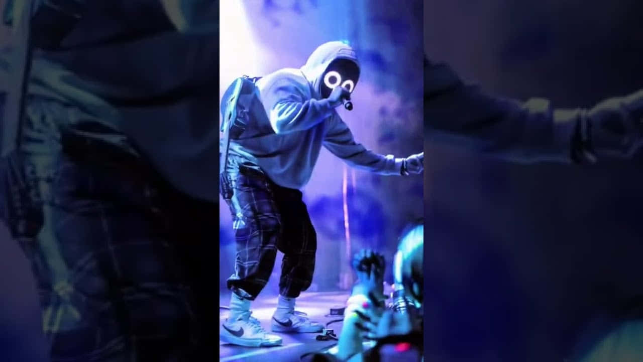 A Man In A Mask On Stage Wallpaper