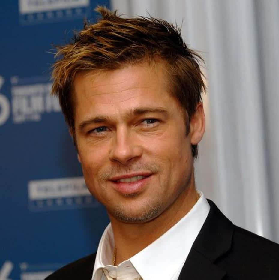 "Brad Pitt looking dapper in a black and white suit."