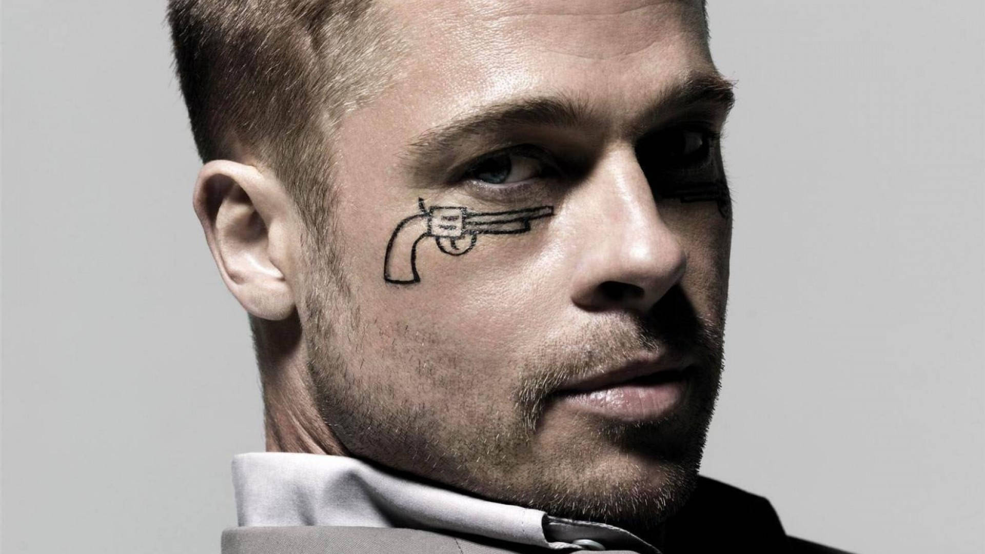 Brad Pitt sporting a gun tattoo in his eye Wallpaper