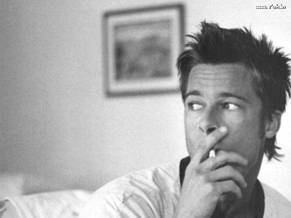 Award-winning Actor Brad Pitt Dressed Up and Smoking in an Intimate Room Wallpaper