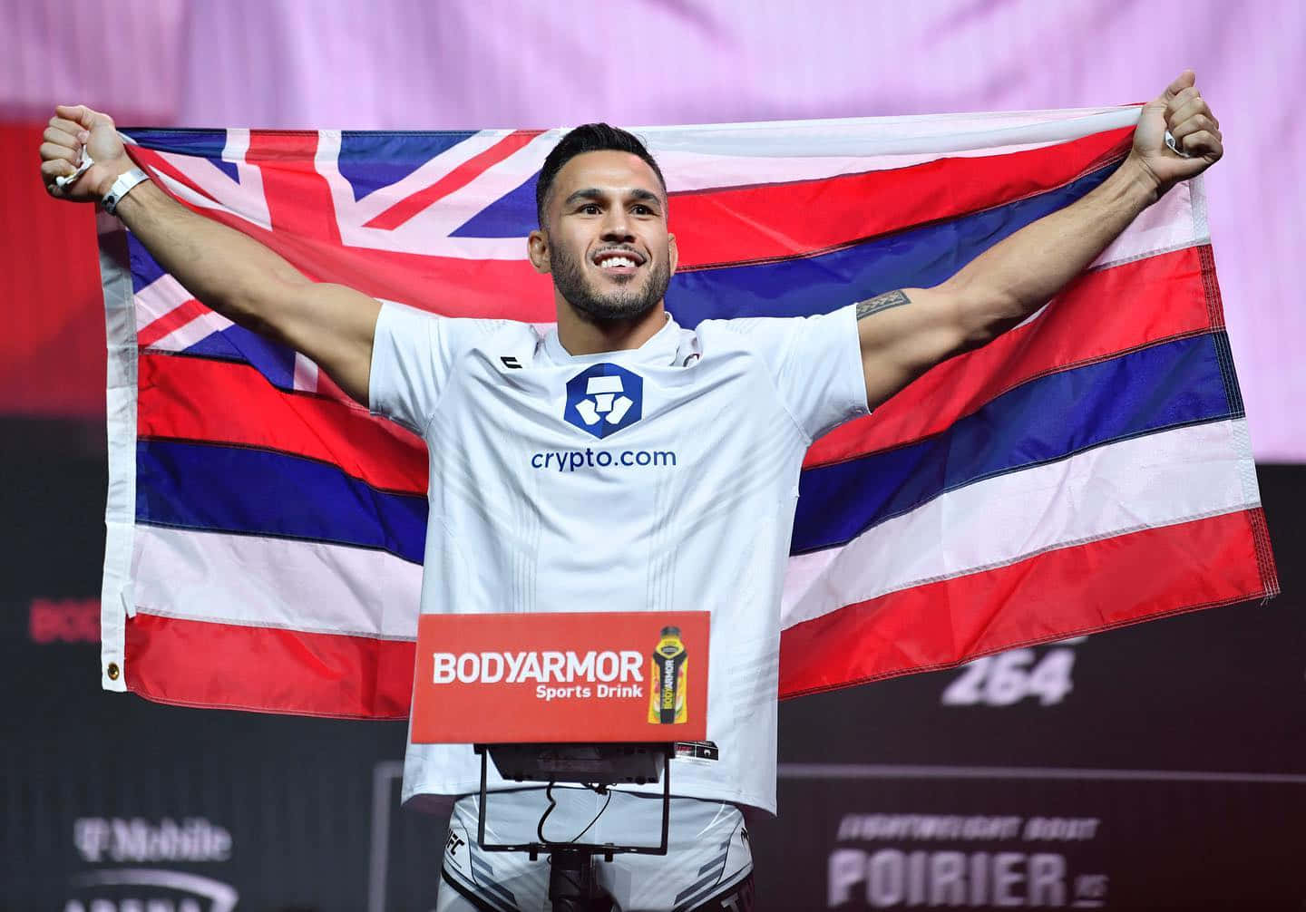 Brad Tavares Cheering And Smiling With A Flag Wallpaper