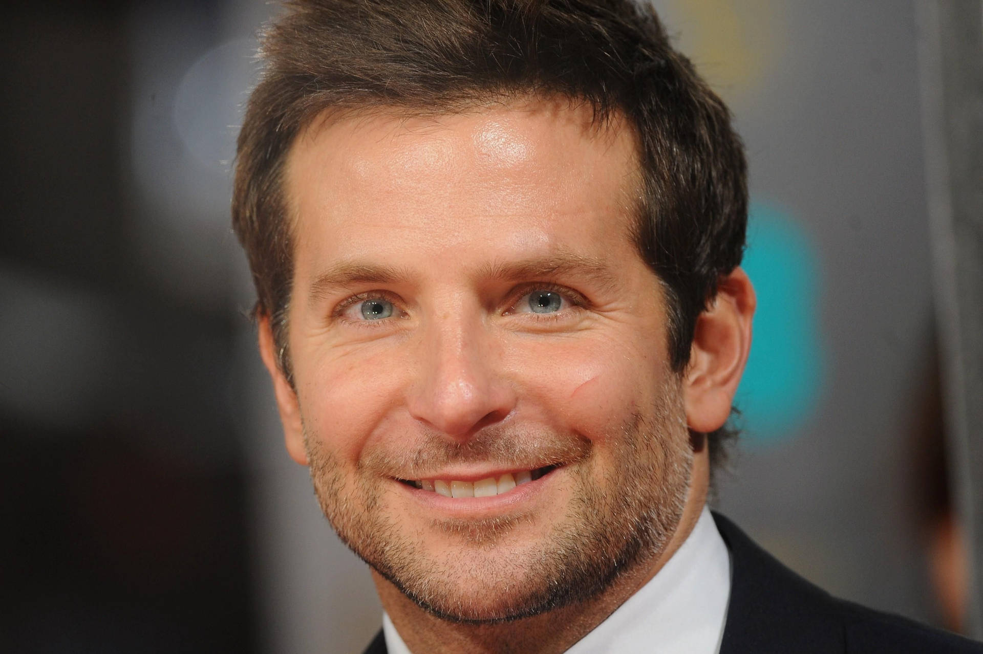 Bradley Cooper Smiling Back At Camera Background