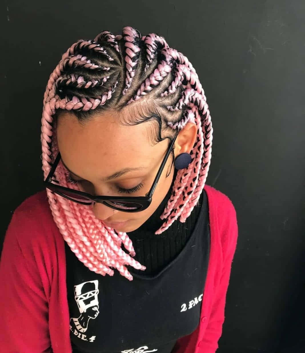A Woman With Pink Braids In Her Hair