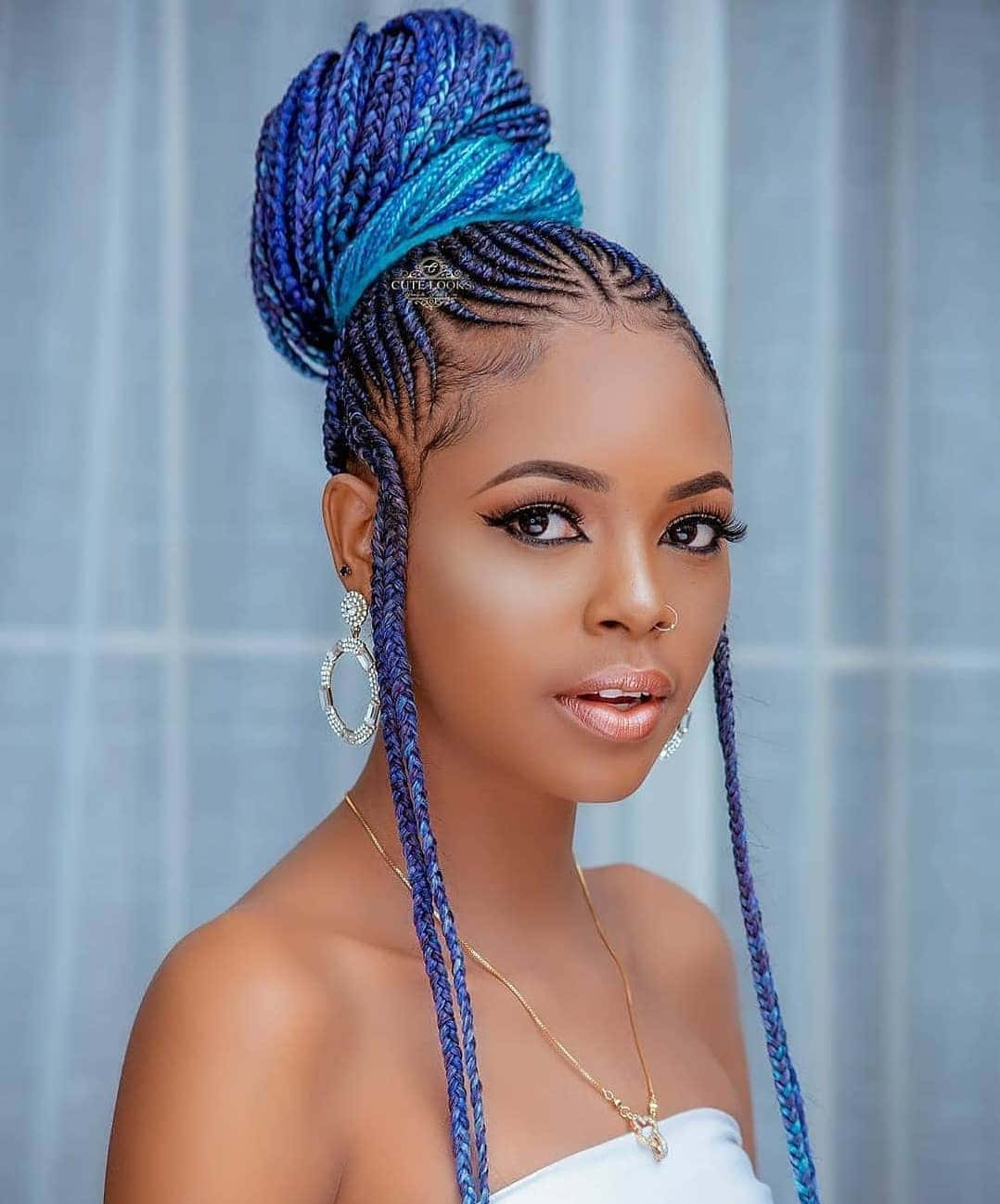 A Beautiful Woman With Braids In Blue And White