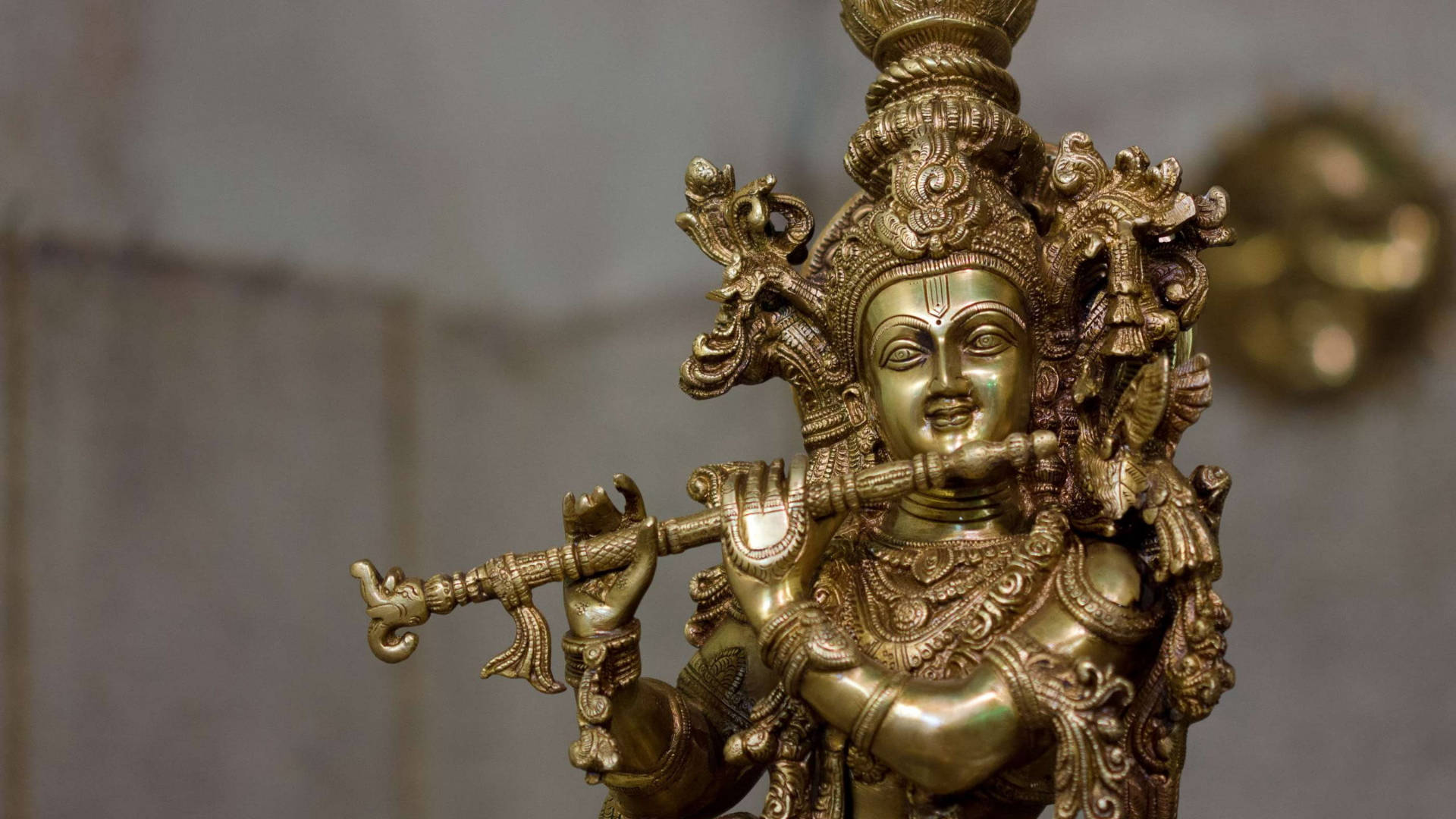 Estatuade Latón Del Dios Hindú Krishna Fondo de pantalla