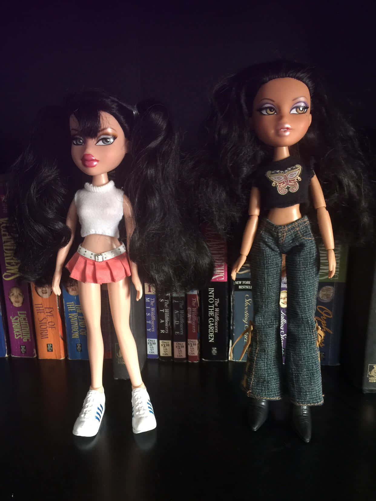 Two Dolls Standing Next To Each Other