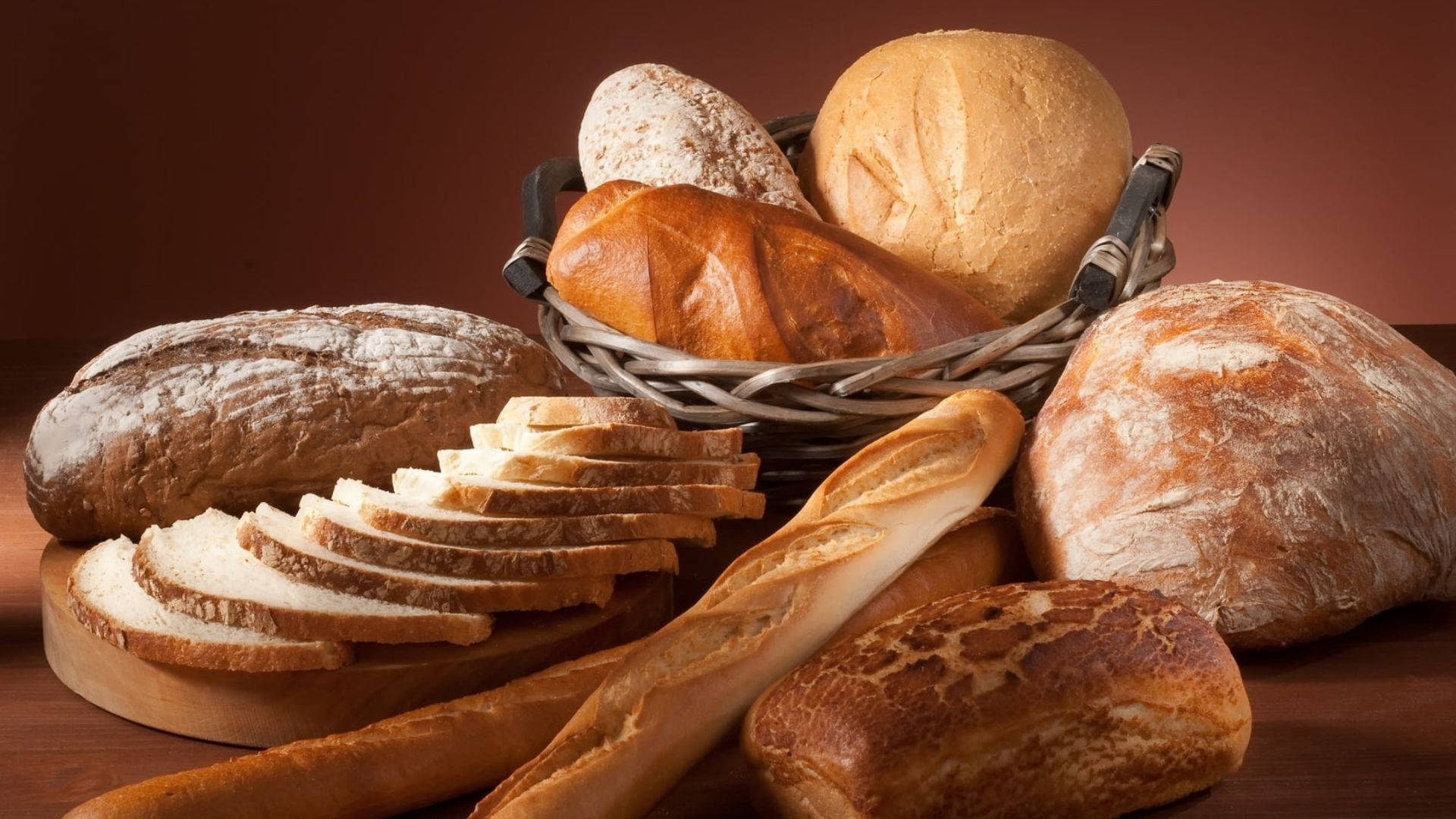 Assortment of breads in a stylish maroon room Wallpaper