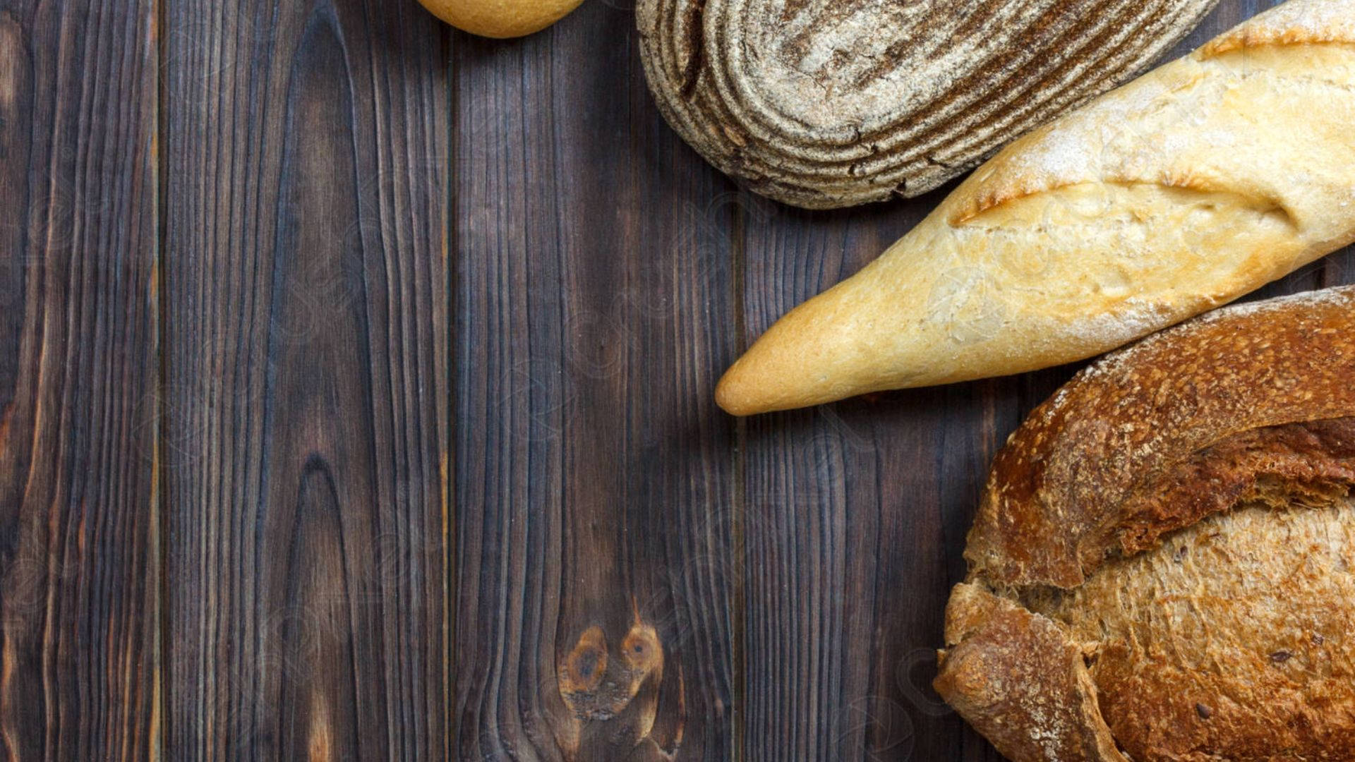 Breads On Dark Wooden Table Wallpaper