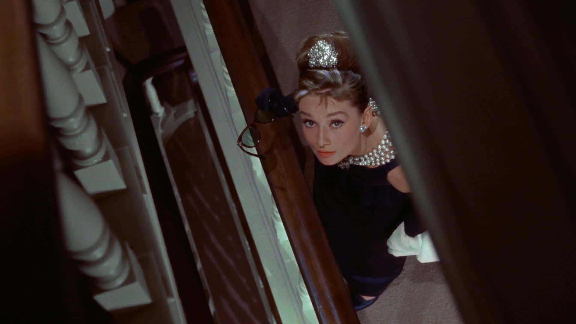 Audrey Hepburn in her iconic role as Holly Golightly in the 1961 classic, Breakfast at Tiffany's Wallpaper