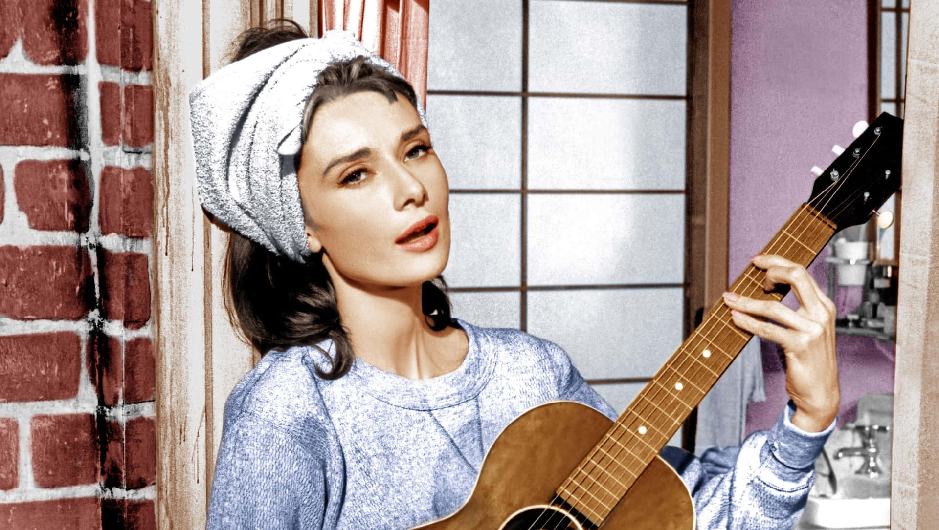 Breakfast At Tiffanys Holly Golightly Singing And Playing Guitar Wallpaper