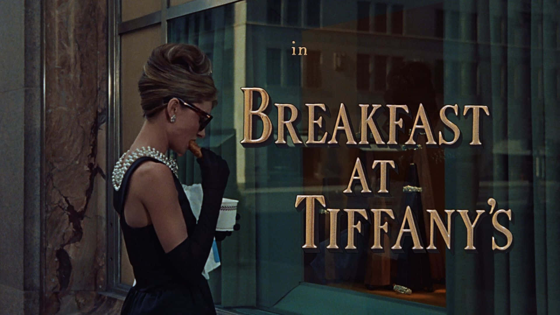 Audrey Hepburn outside of Tiffany's Jewelry looking beautiful in her signature style Wallpaper