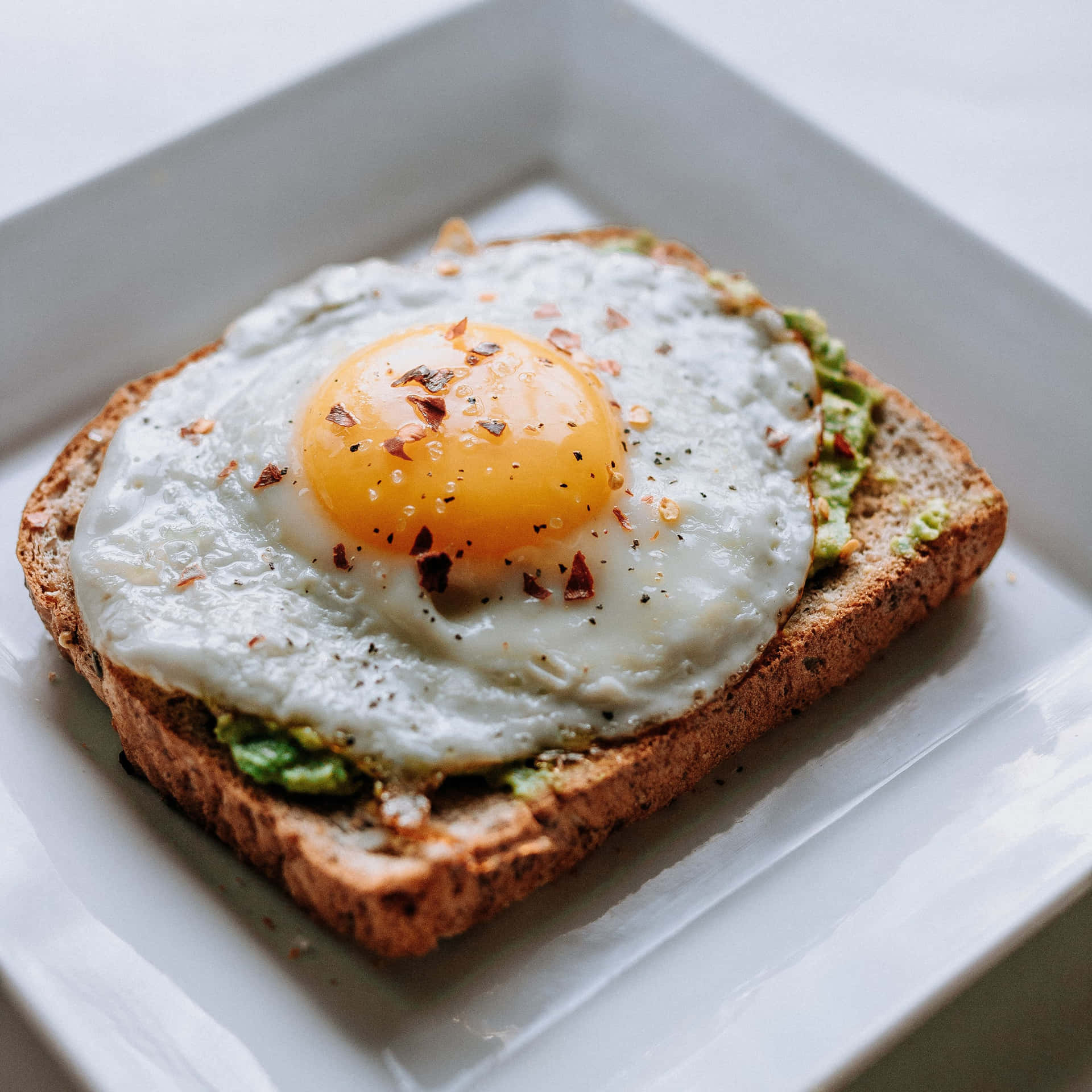 A Square Plate With A Toast And An Egg On It