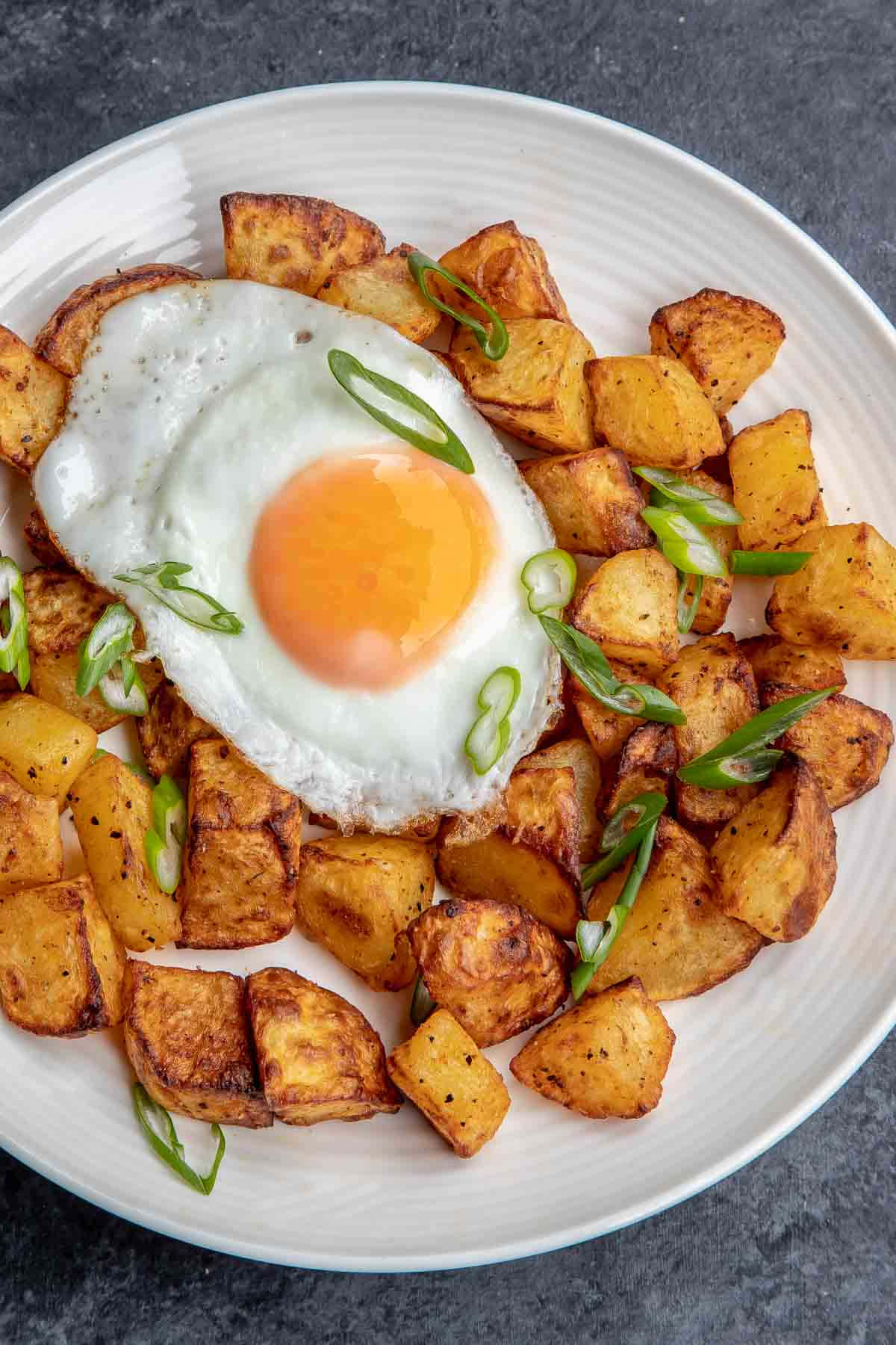 Fried Potatoes With A Fried Egg On A Plate