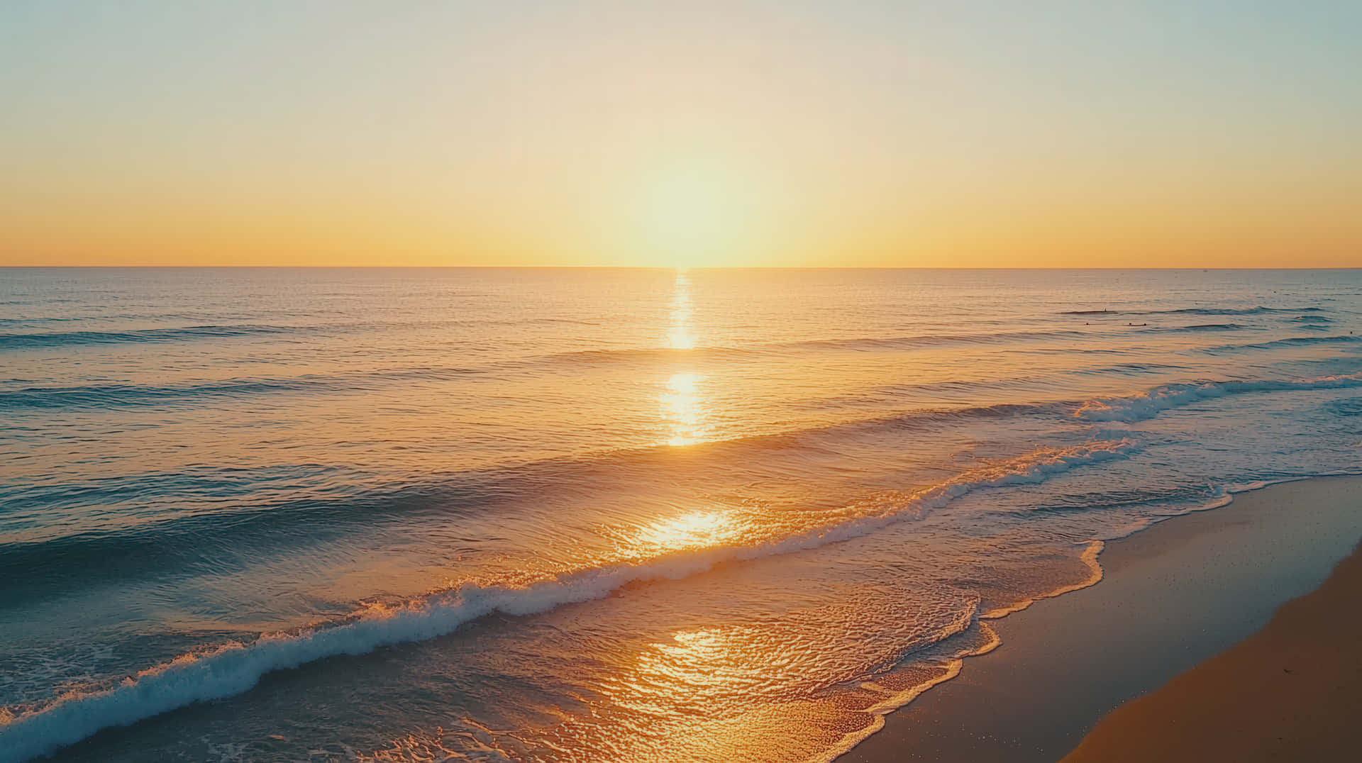 Breathtaking Ocean Sunset With Golden Reflections On Gentle Waves And A Serene Beach Horizon Wallpaper