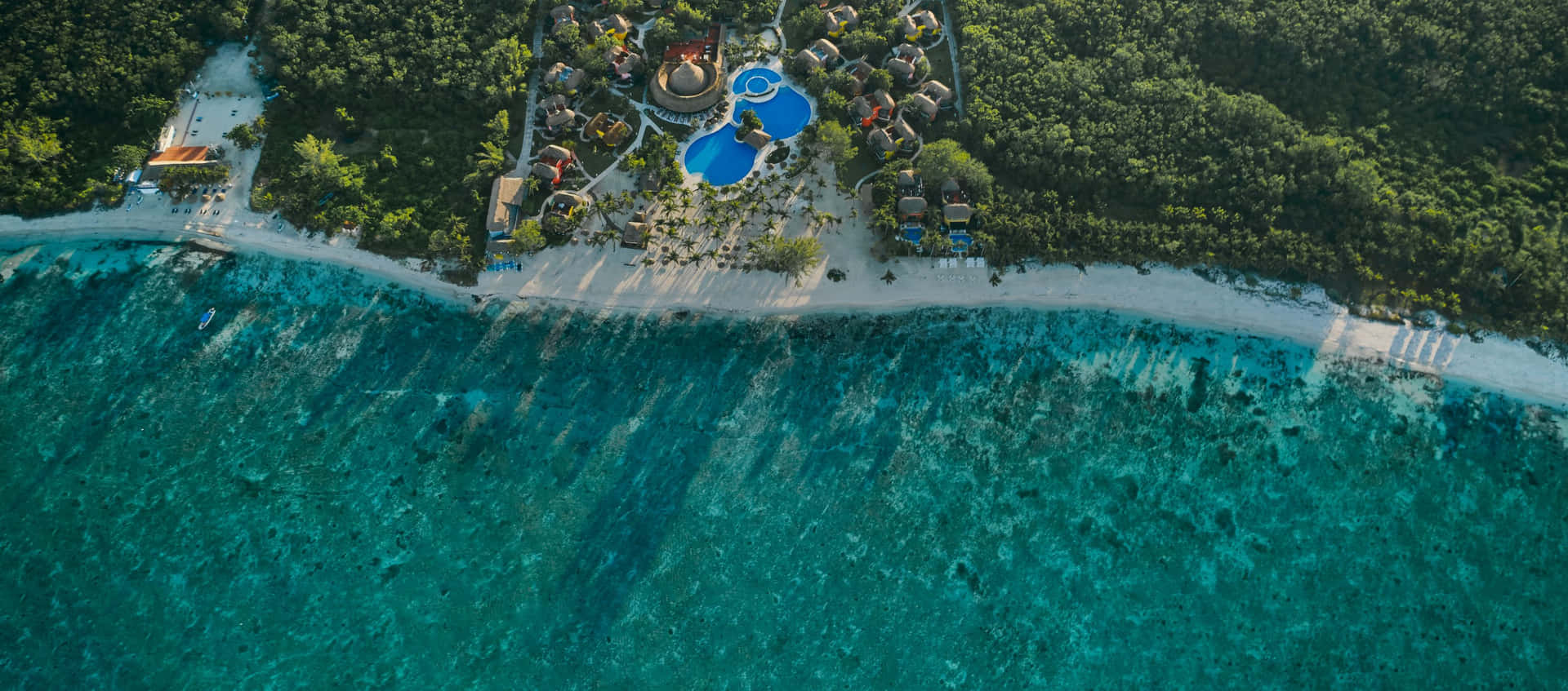 Breathtaking View Of A Tranquil Beach Resort Wallpaper